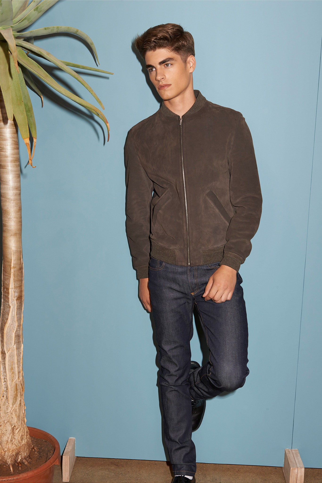 brown suede fitted jacket and blue jeans