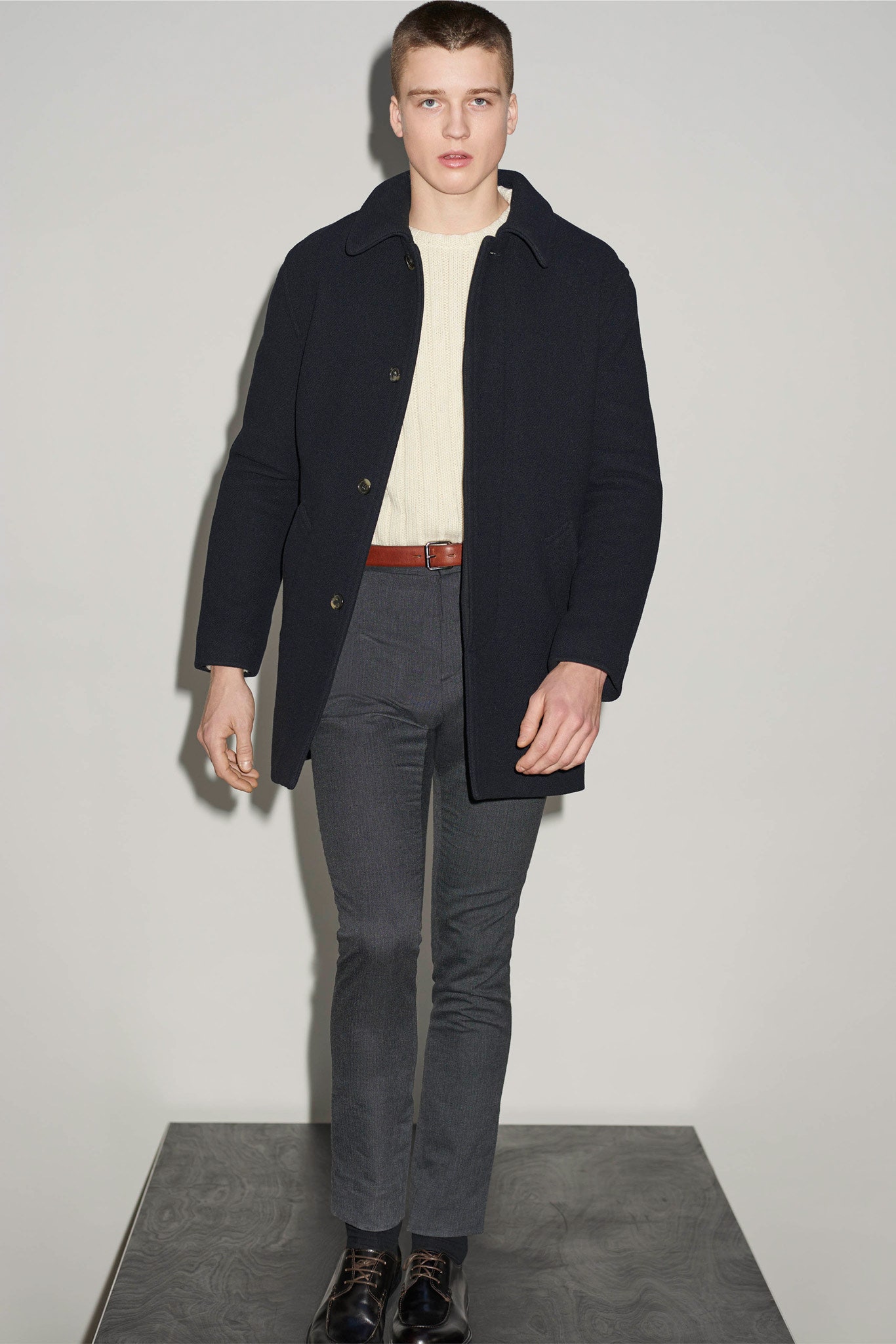 black wool coat with ivory sweater
