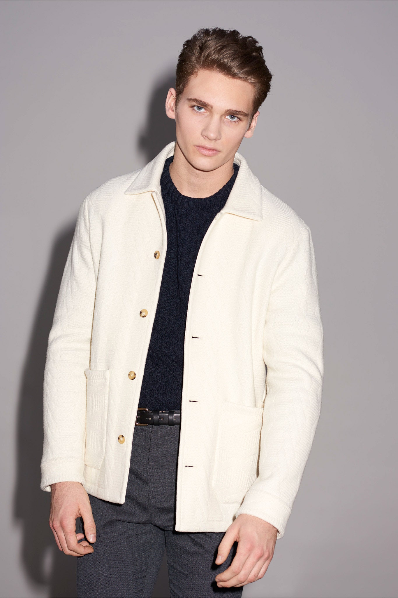 white jacket black sweater gray pants