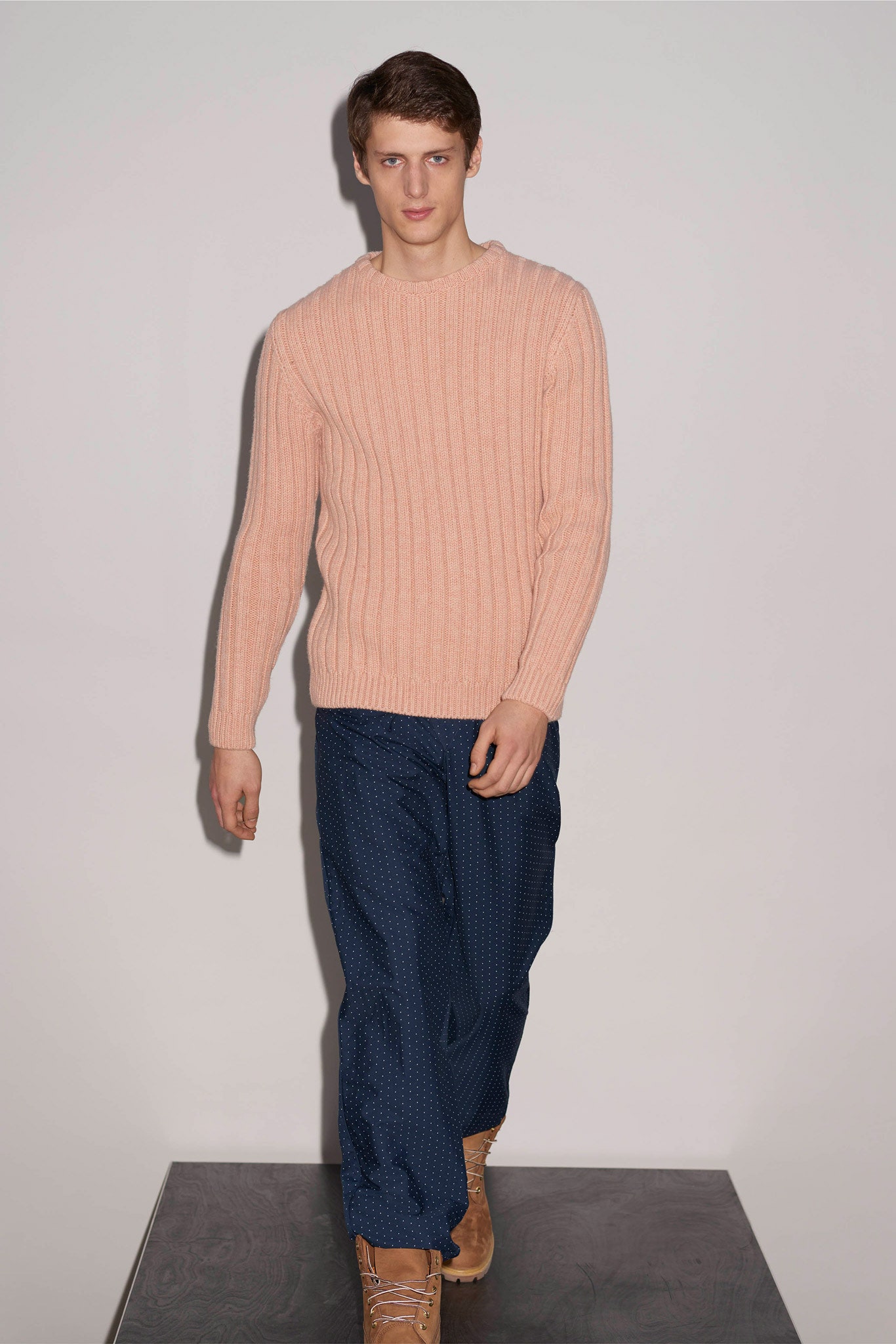 pink ribbed sweater and blue pants
