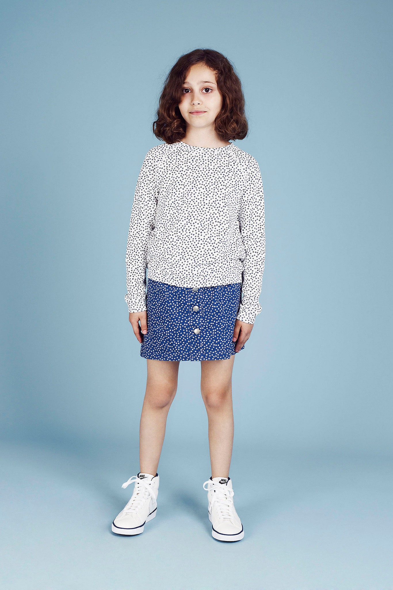 white printed long-sleeve top with blue skirt