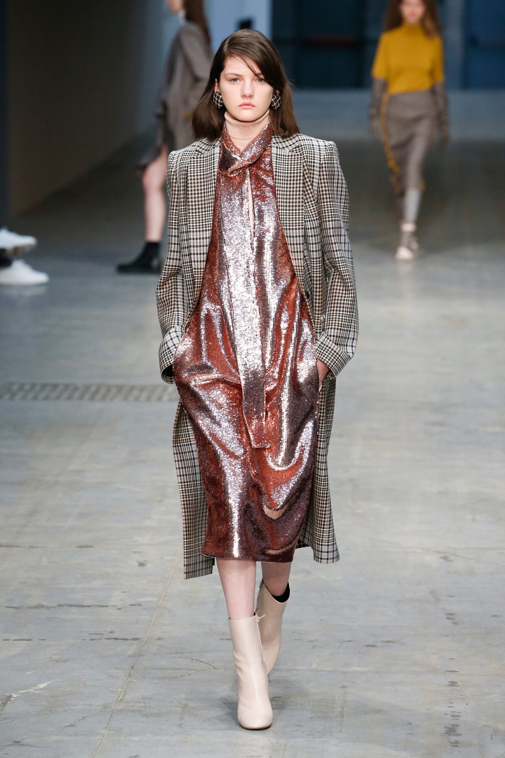 checked coat and shiny dress