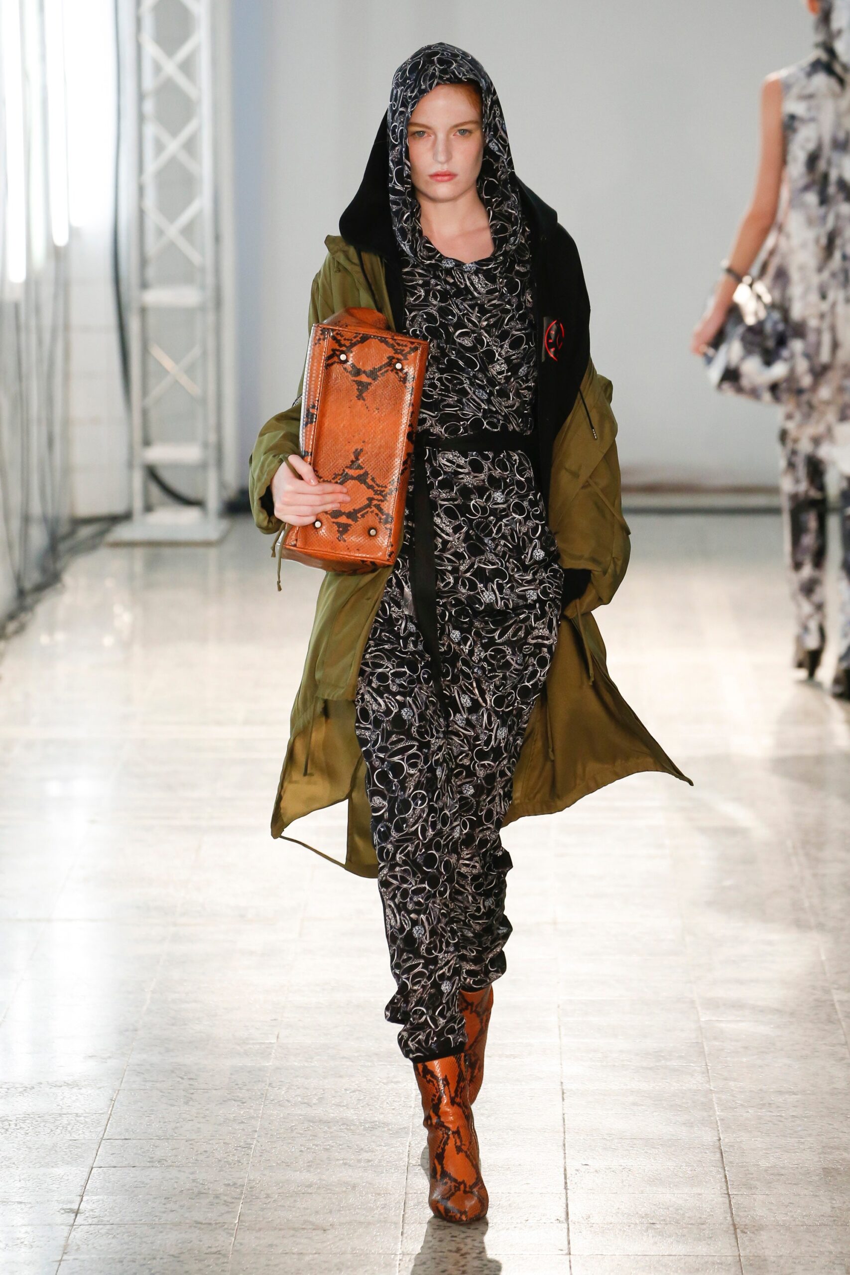 green jacket with black jumpsuit