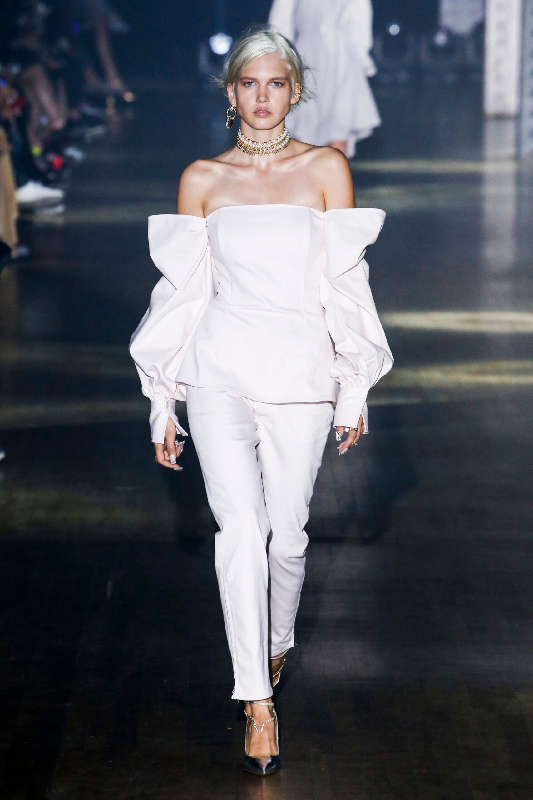 white silk off-shoulder top with fitted pants