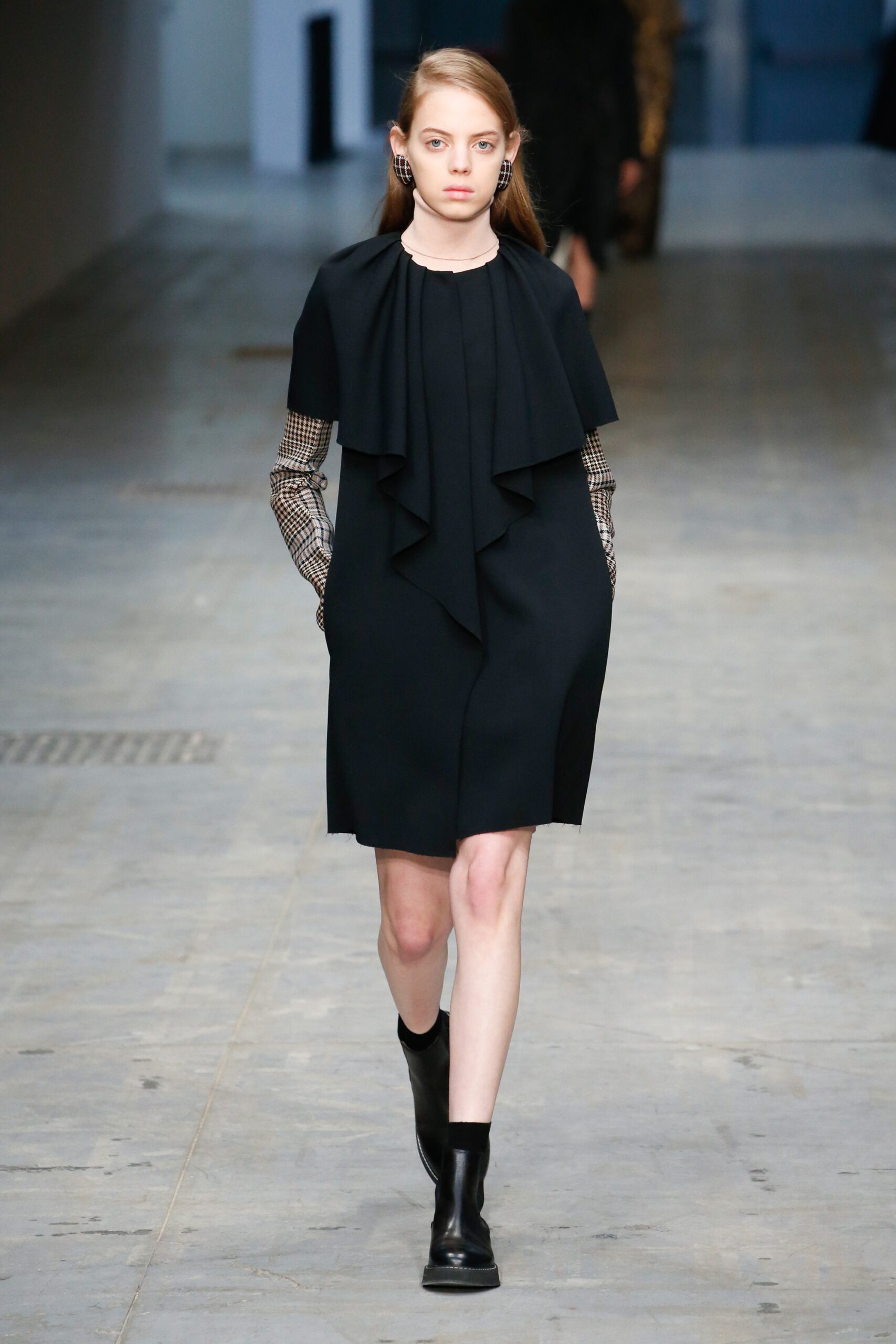 black fitted dress with draped detail