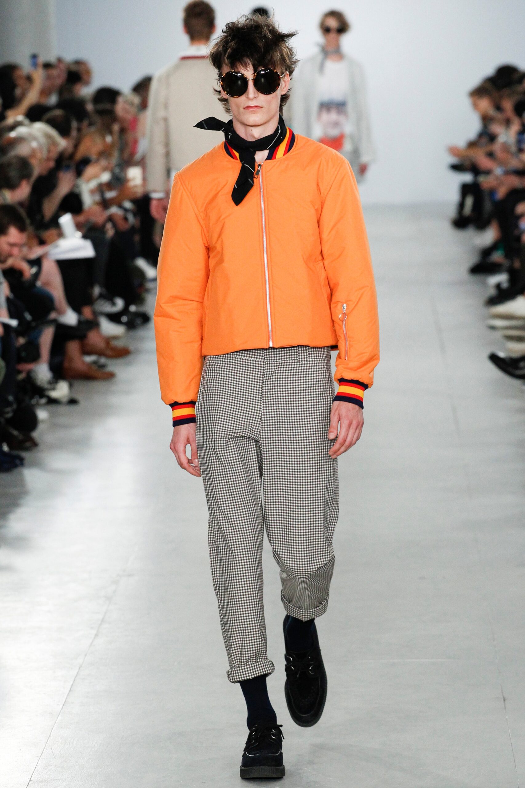 fitted orange jacket and gray pants