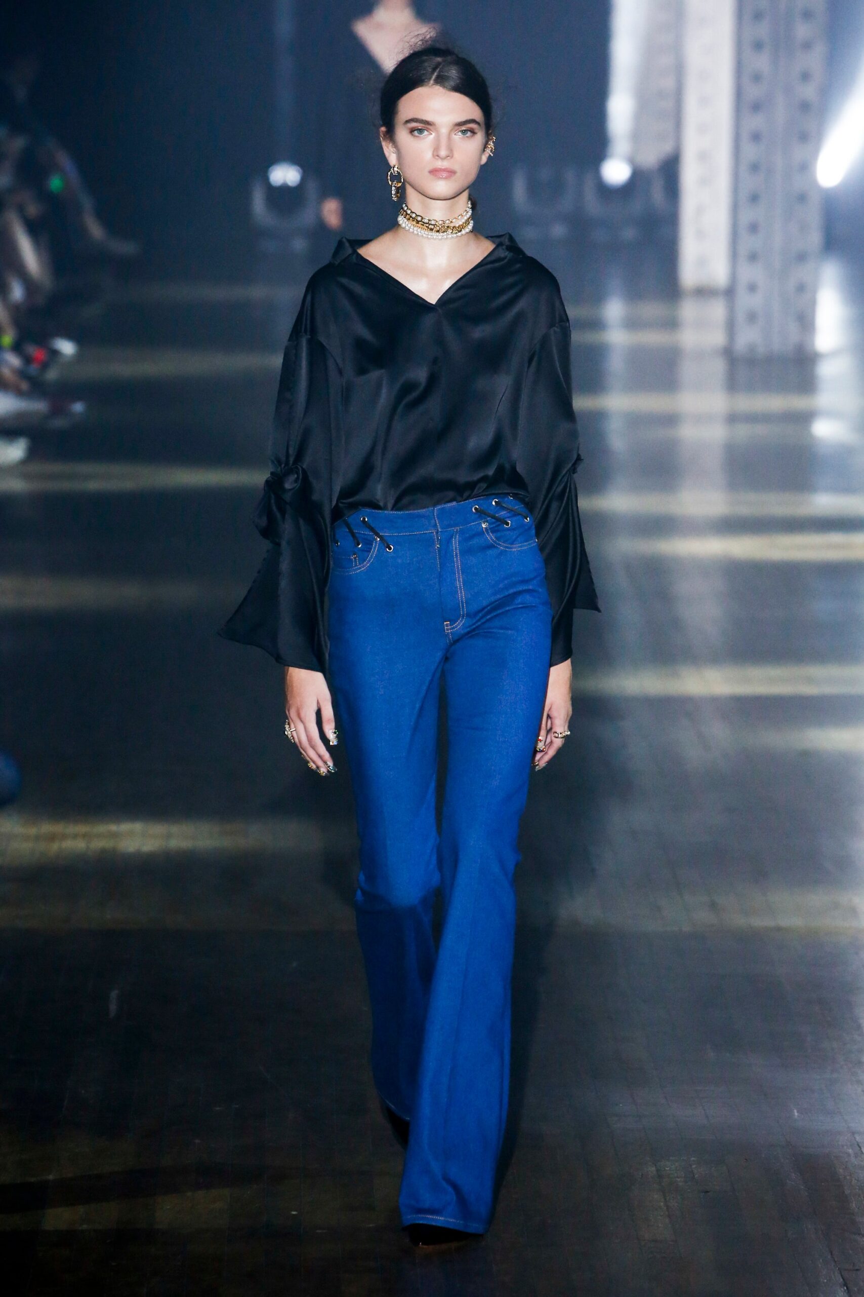 black silk top with blue flared pants