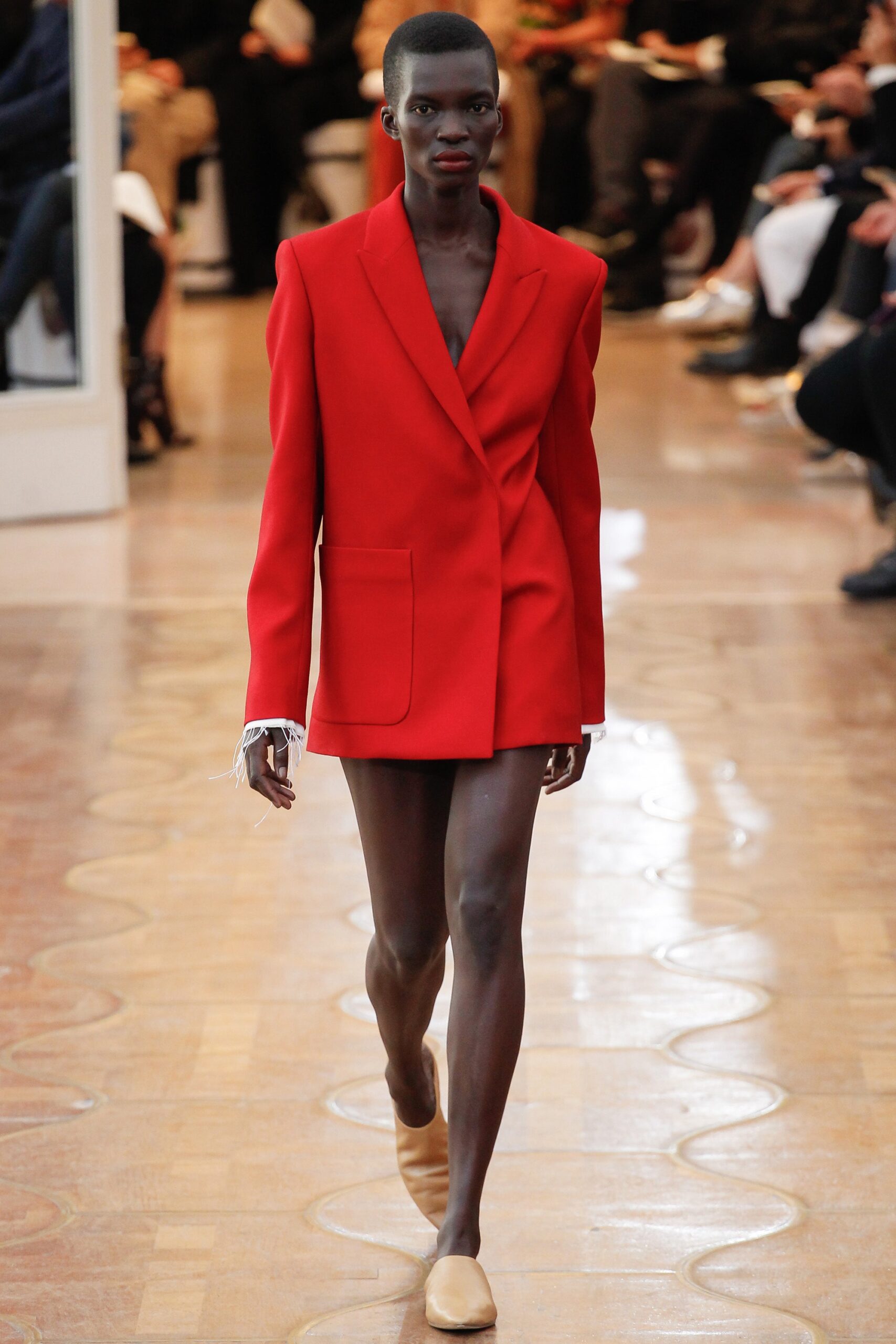 red fitted blazer with beige shoes