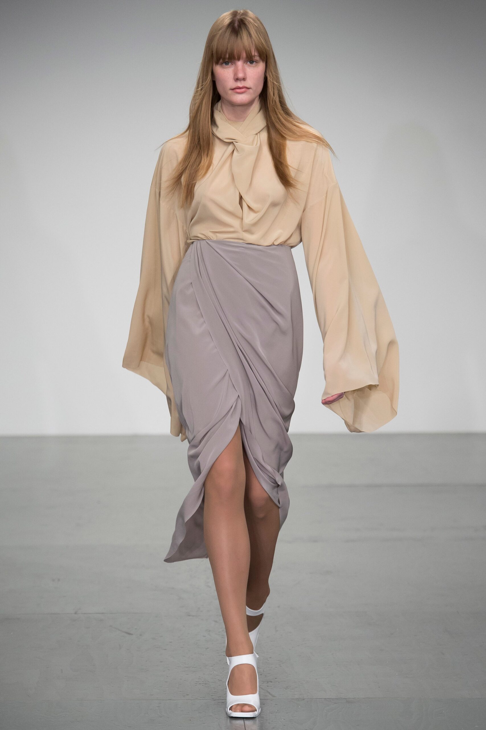 beige silk blouse with gray skirt