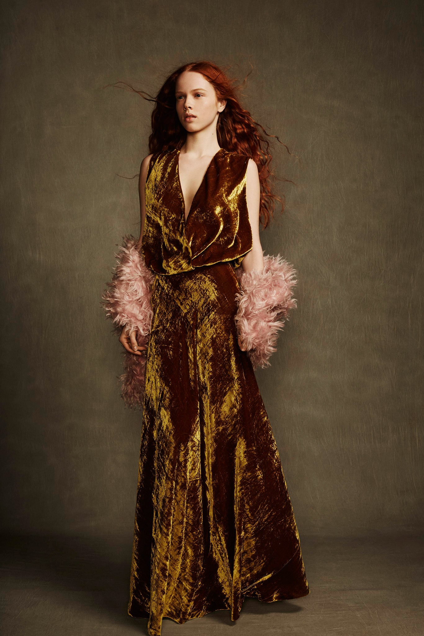 brown gold velvet gown with feather accessory