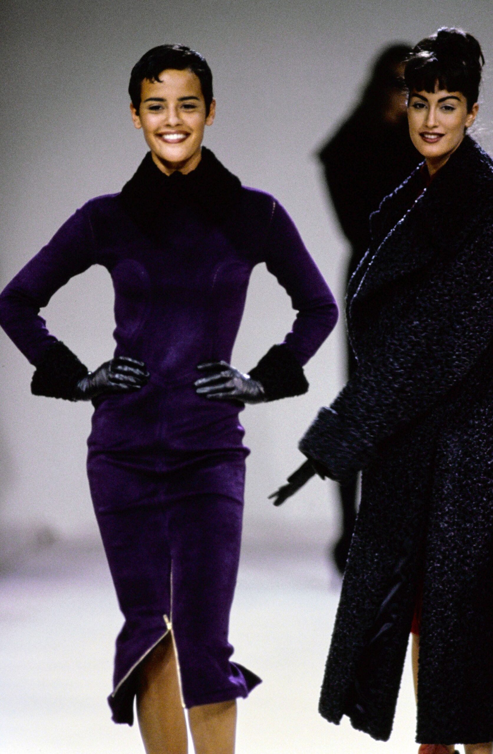 purple velvet fitted dress and black coat