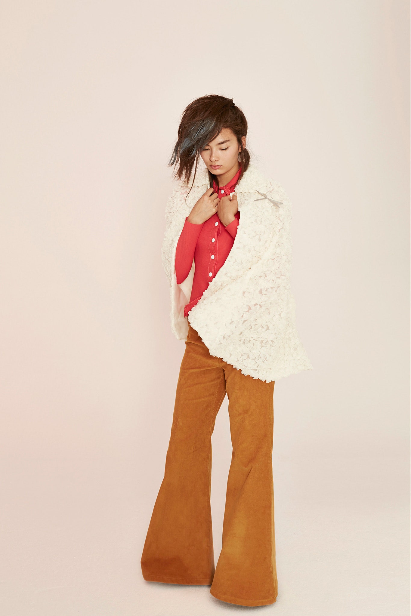 red fitted top with white cape