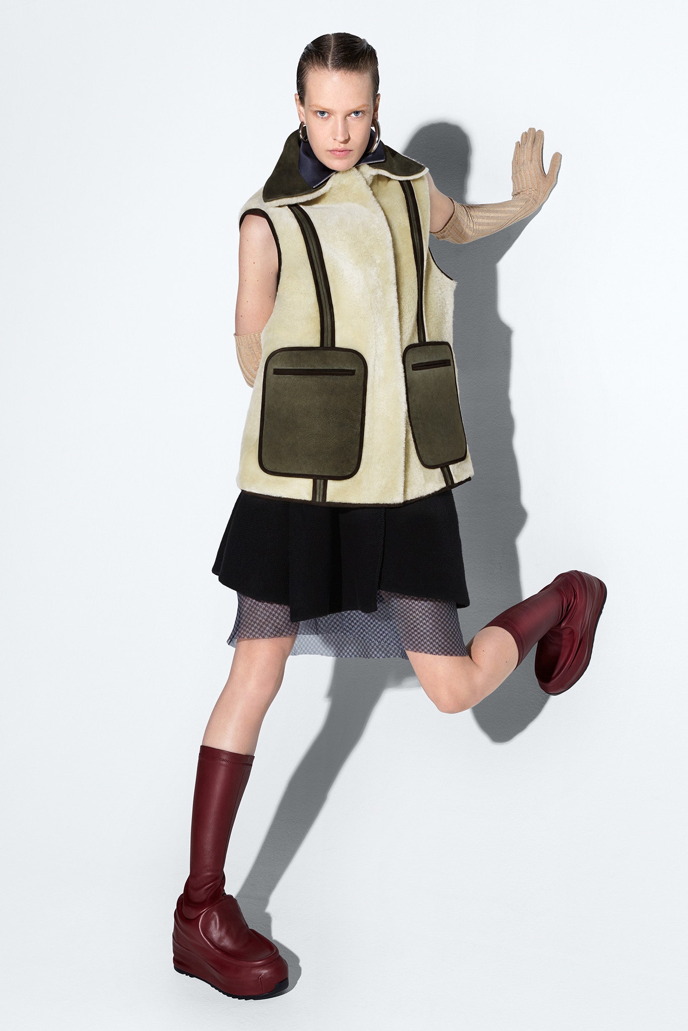 beige faux-fur vest with black mini skirt