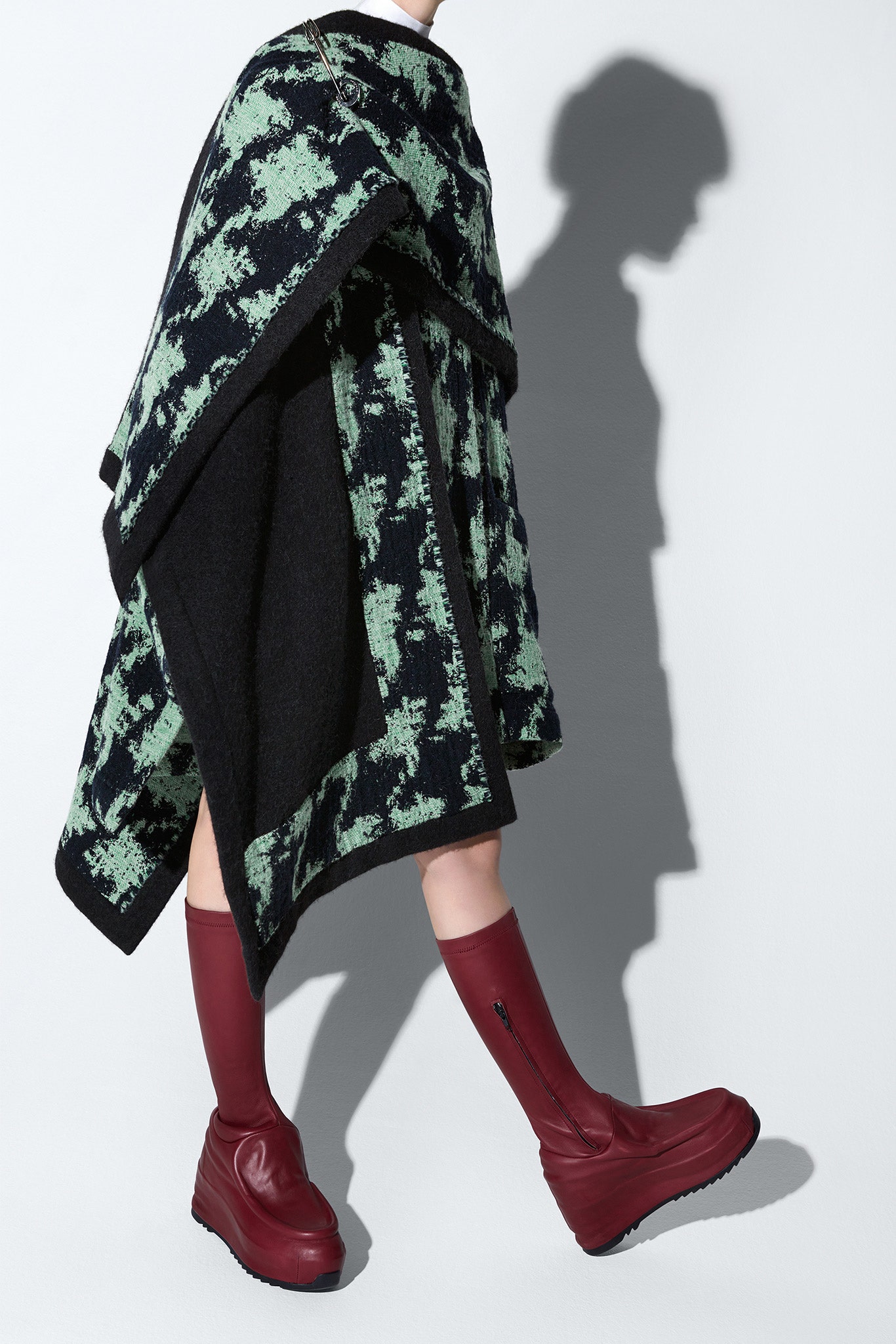 green black wool poncho with red boots