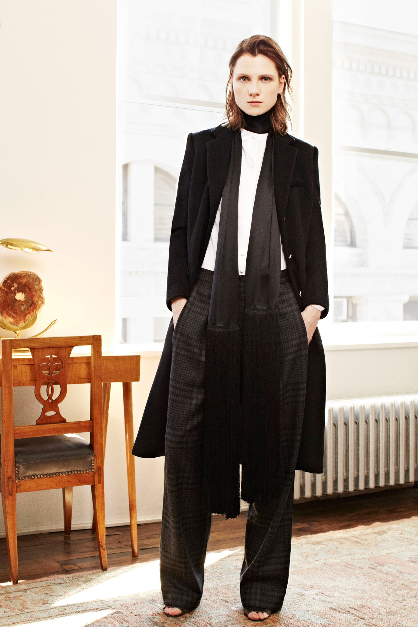 black coat white blouse gray pants