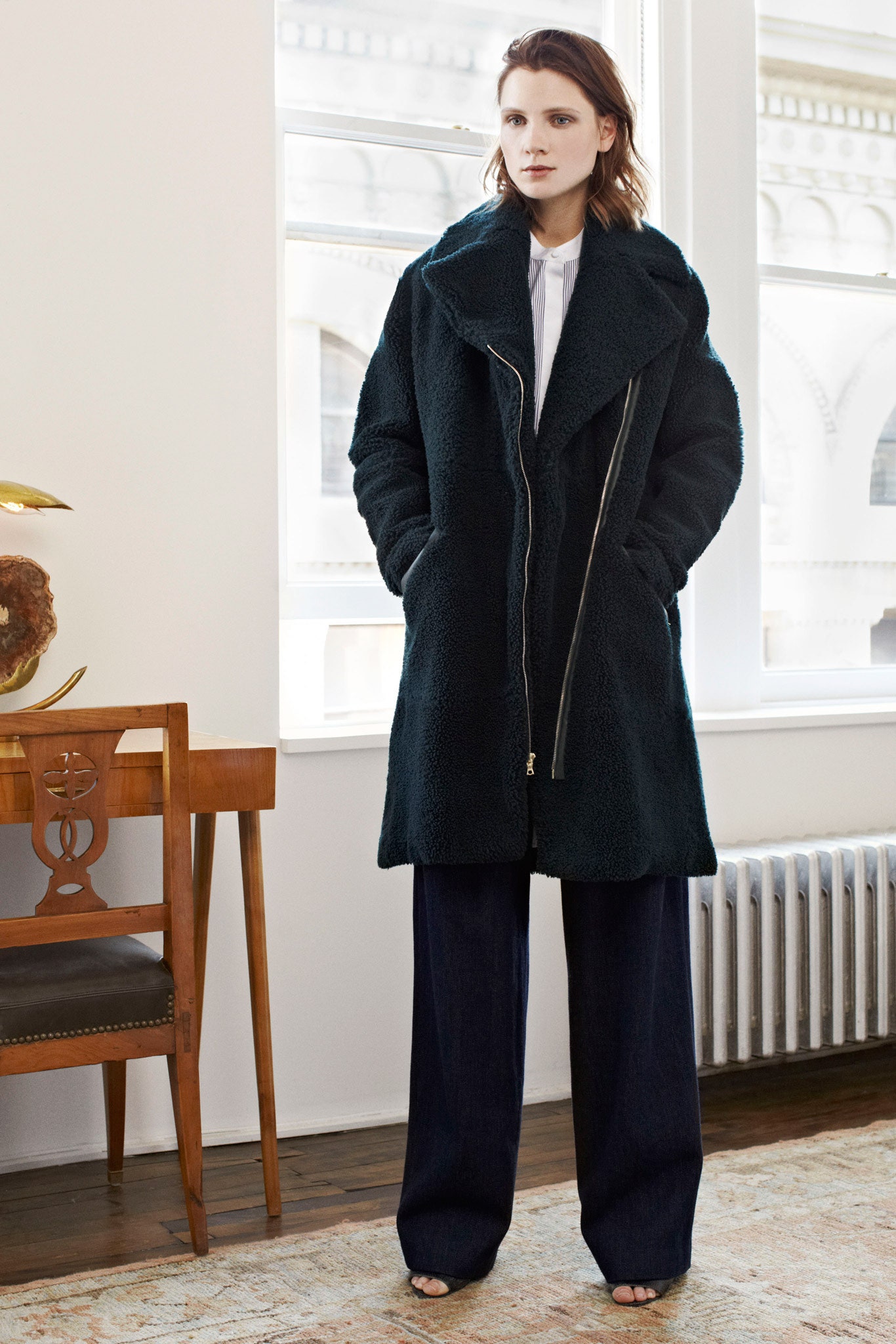 black faux-fur coat and blue denim pants