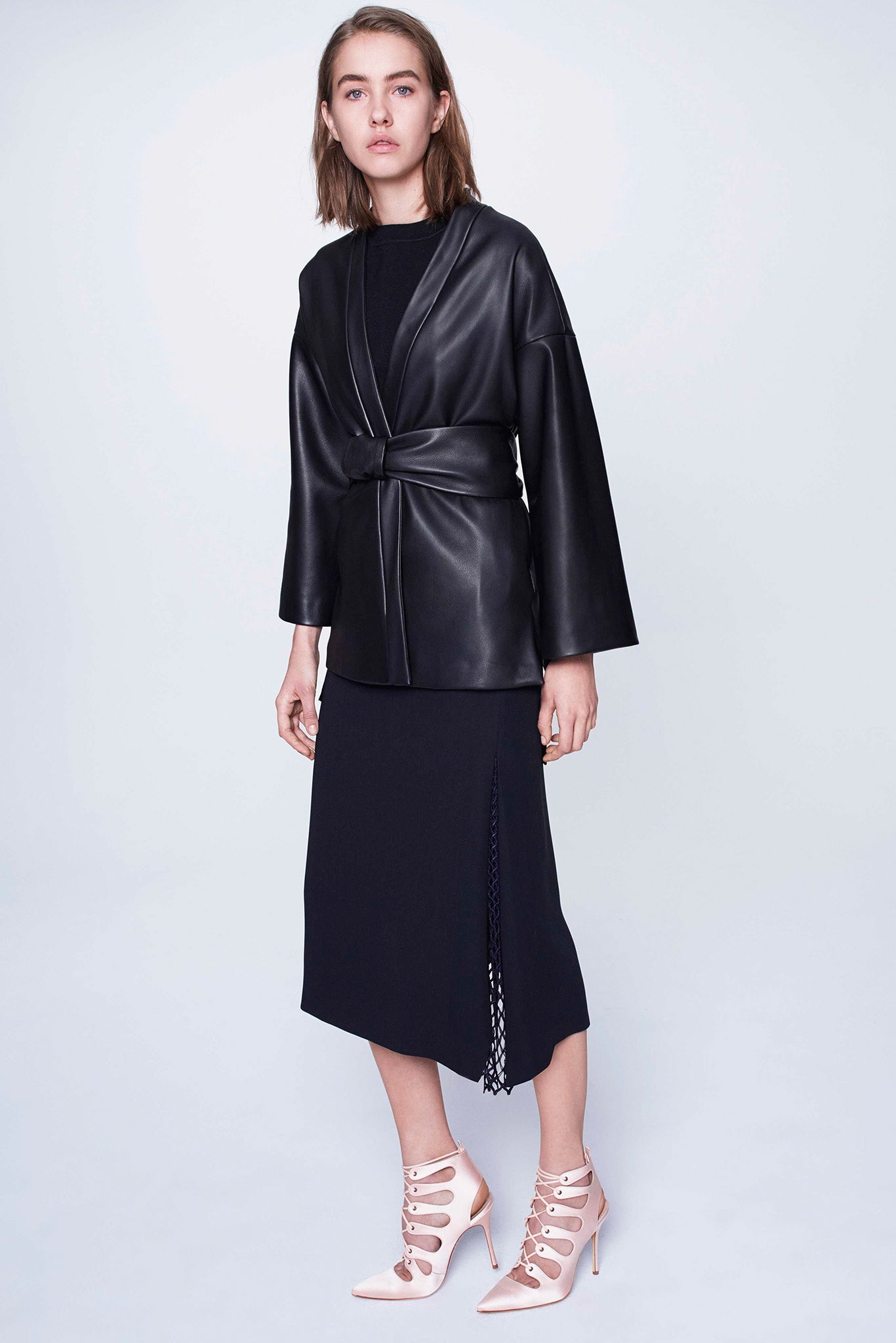 black leather jacket with navy skirt