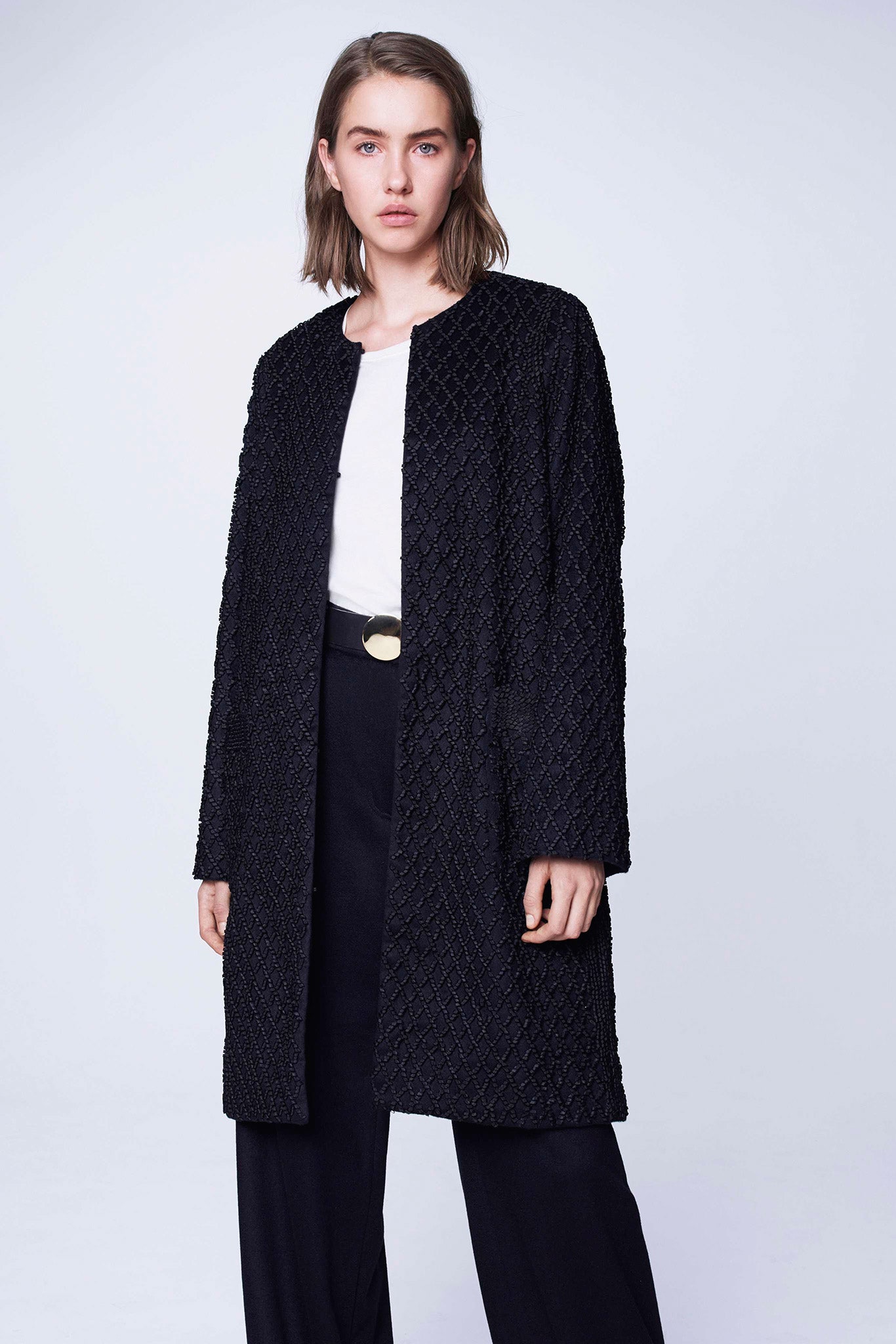 black coat white top black pants