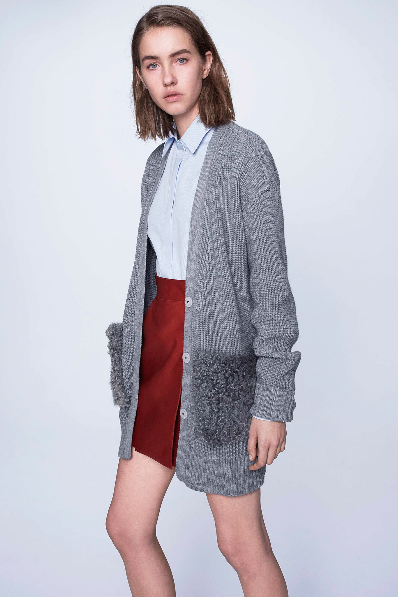 gray cardigan with blue shirt and red skirt