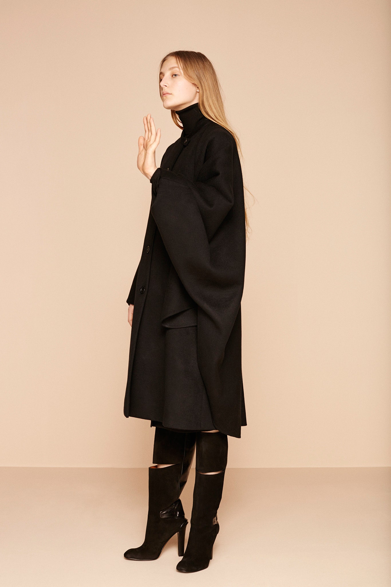 black wool coat and leather boots