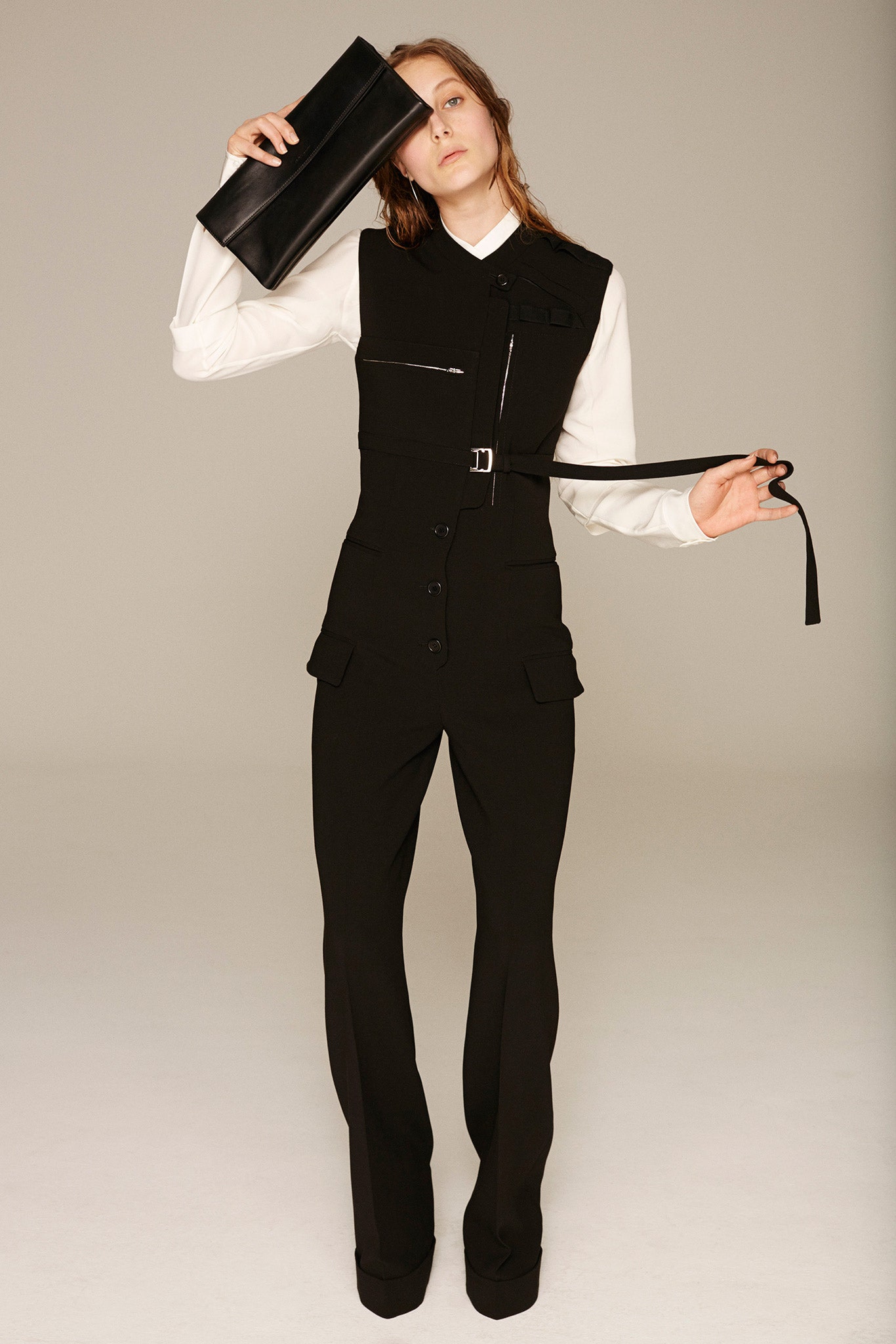 black fitted jumpsuit with clutch