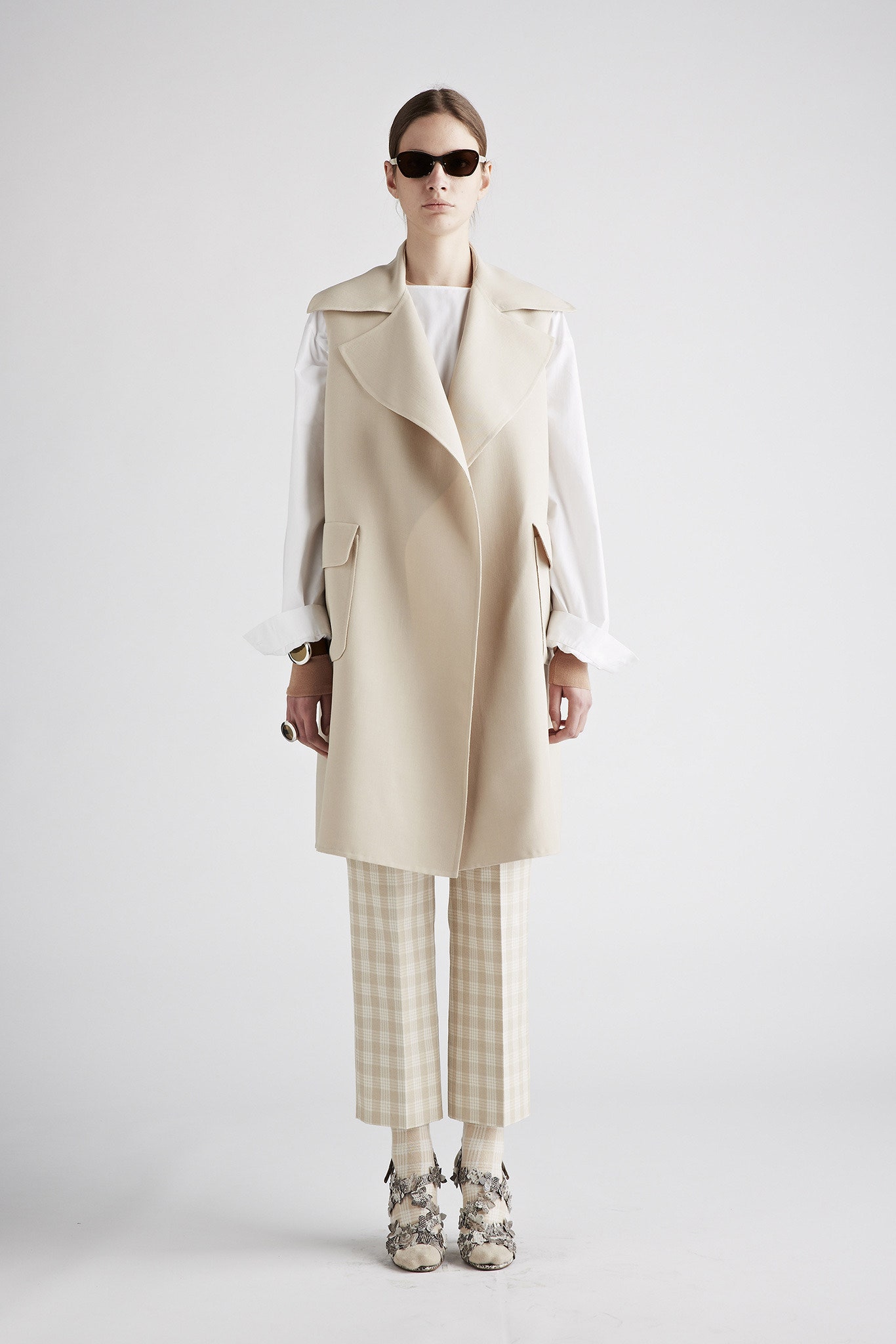 beige coat with white blouse