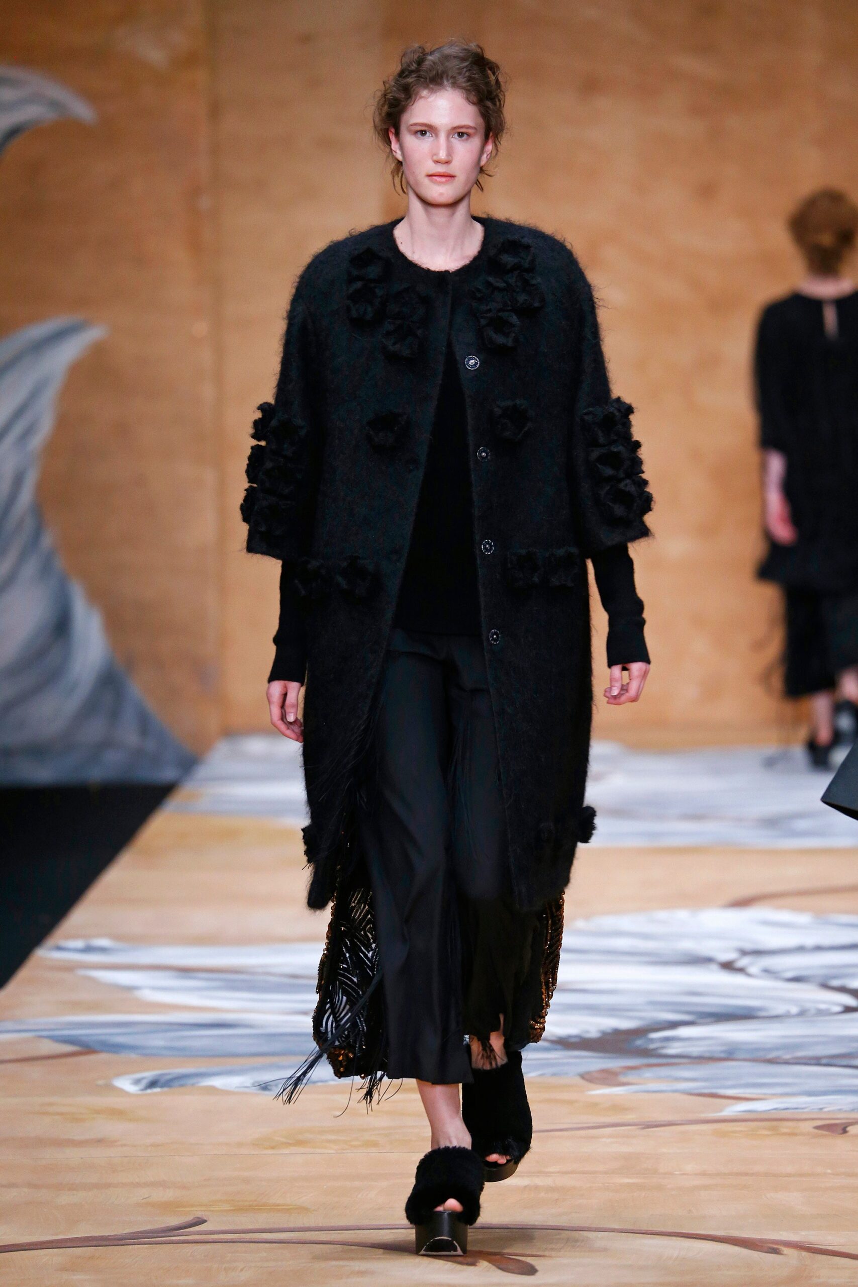 black wool coat with fringed pants