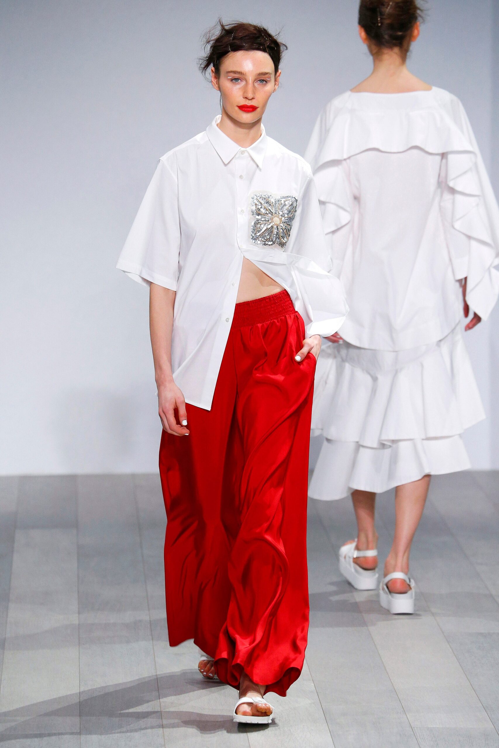 white relaxed shirt red wide-leg pants