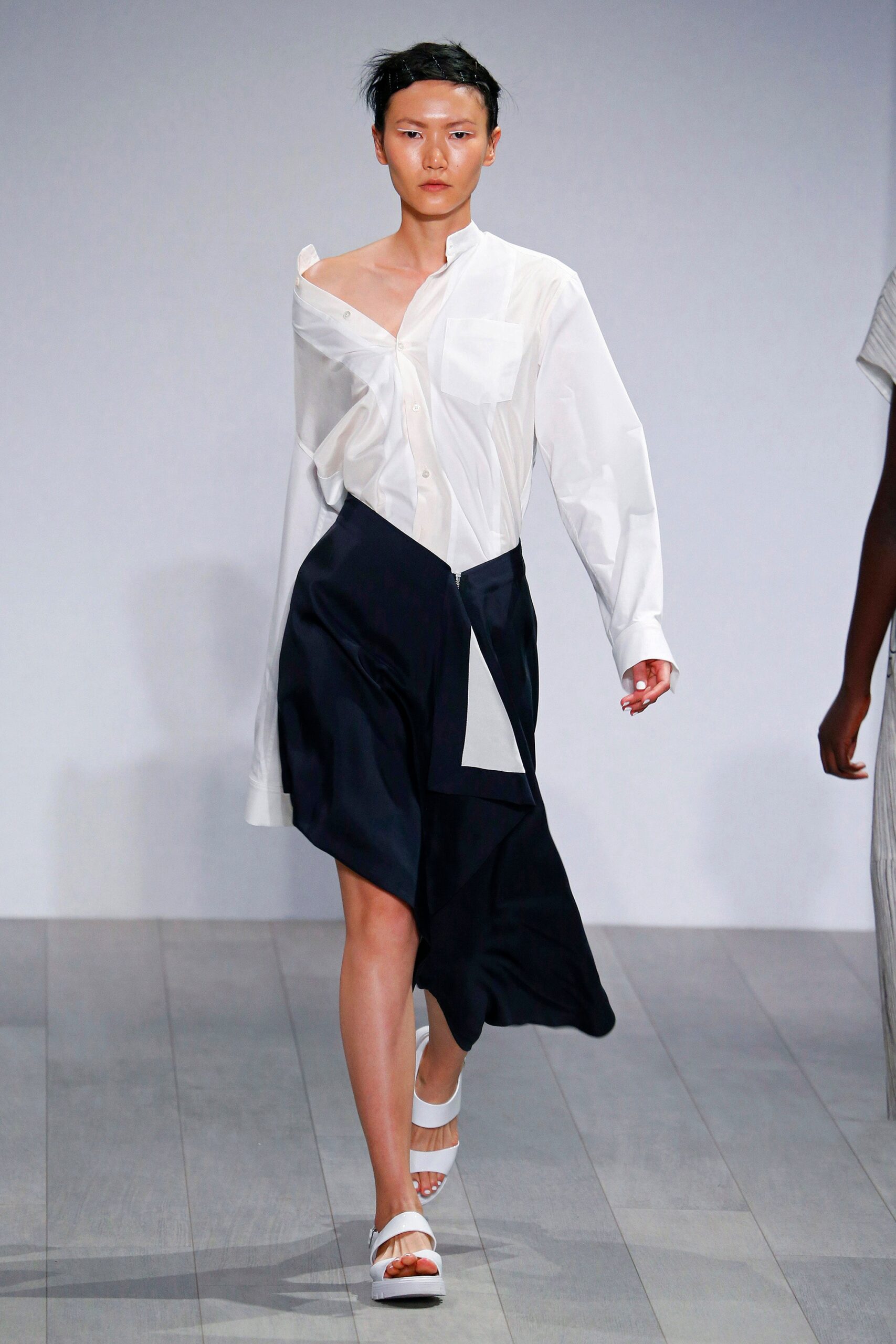white relaxed shirt and black skirt