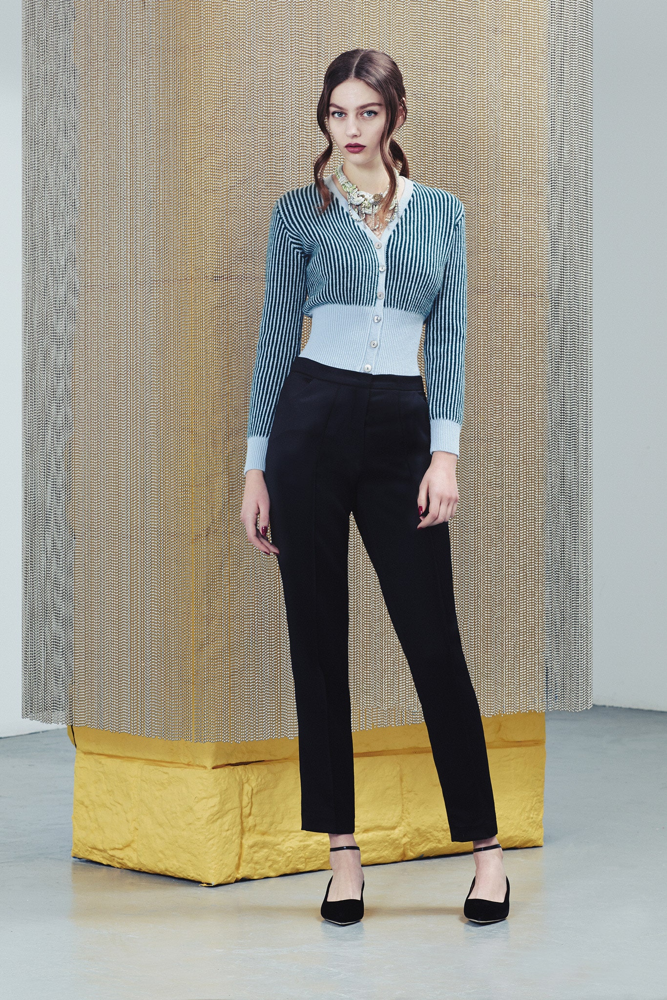 blue striped fitted cardigan and black tailored pants