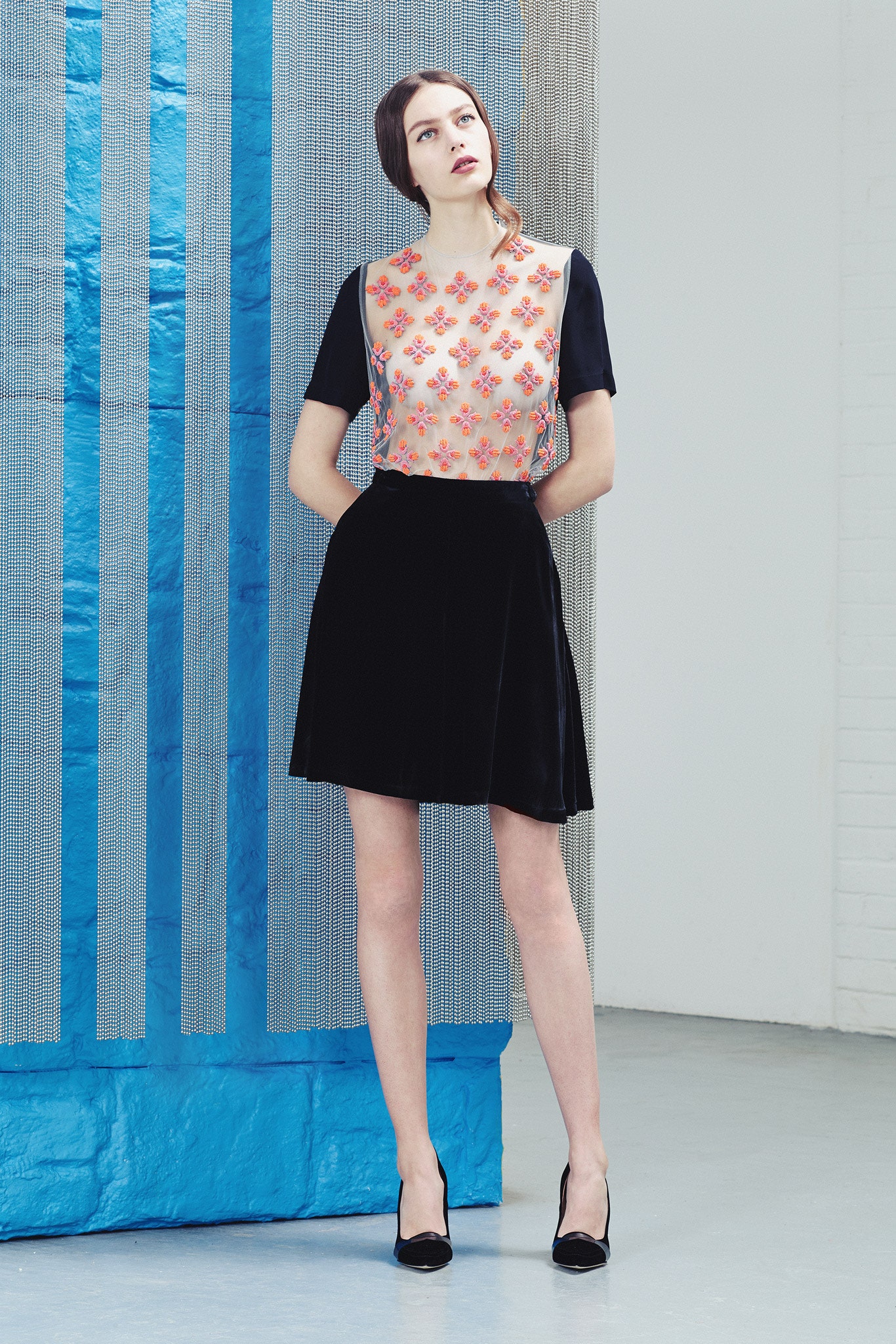 pink embroidered top with black skirt