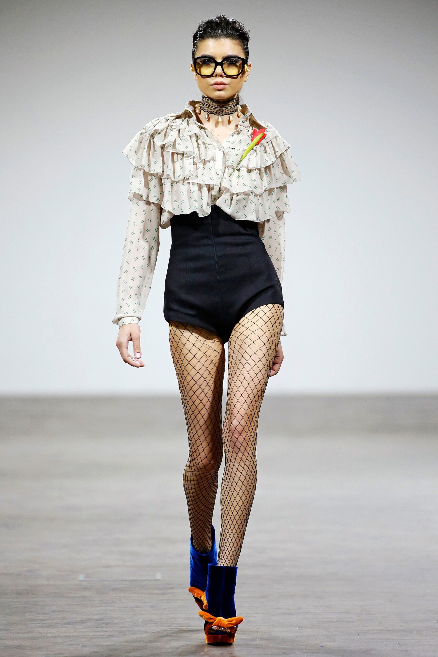 white ruffled blouse with black shorts