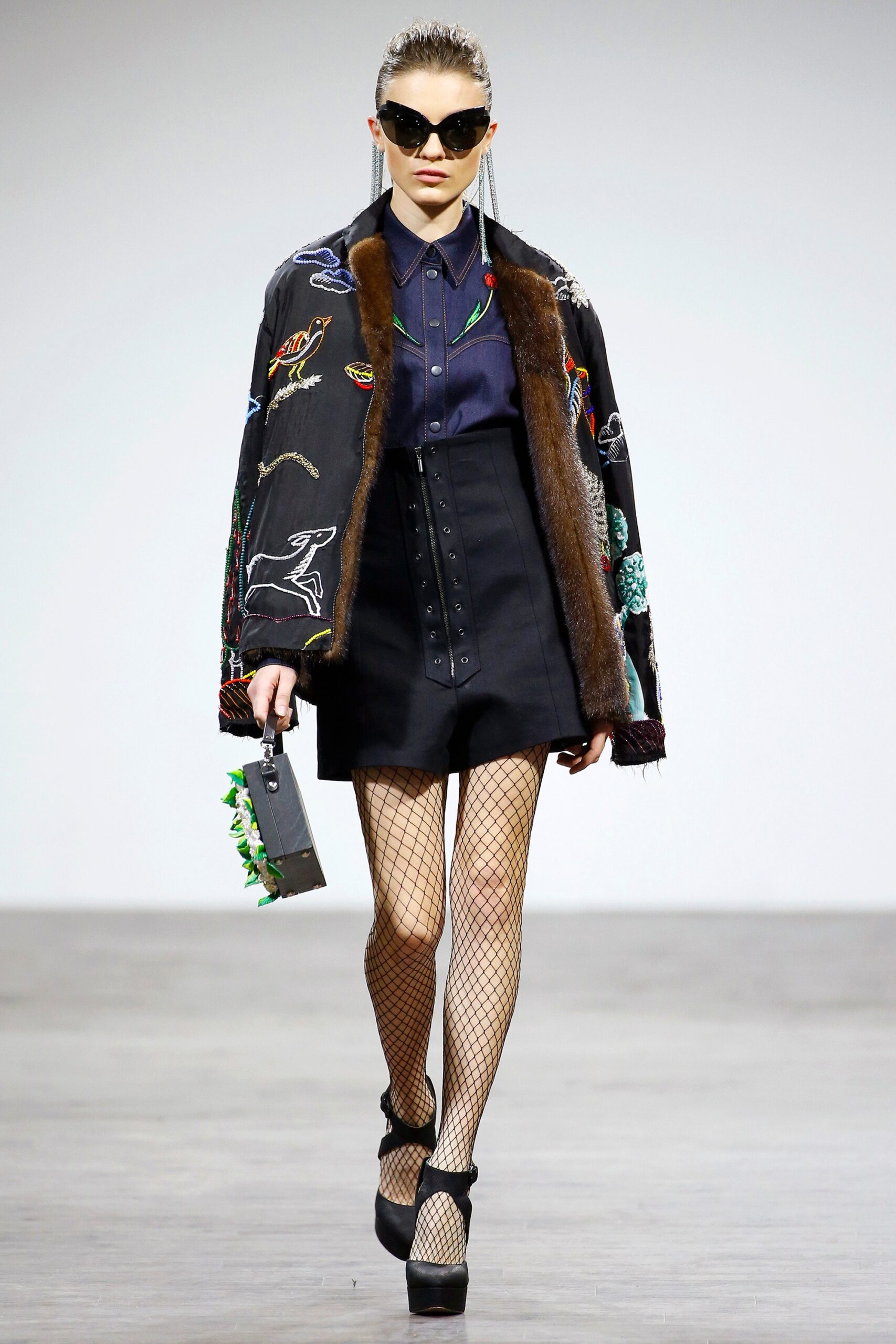 black embroidered jacket with blue shirt