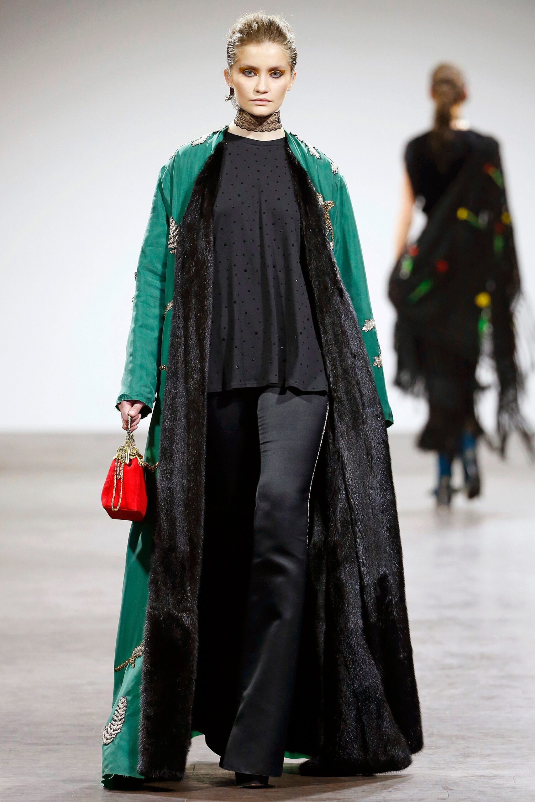green embroidered coat with black top
