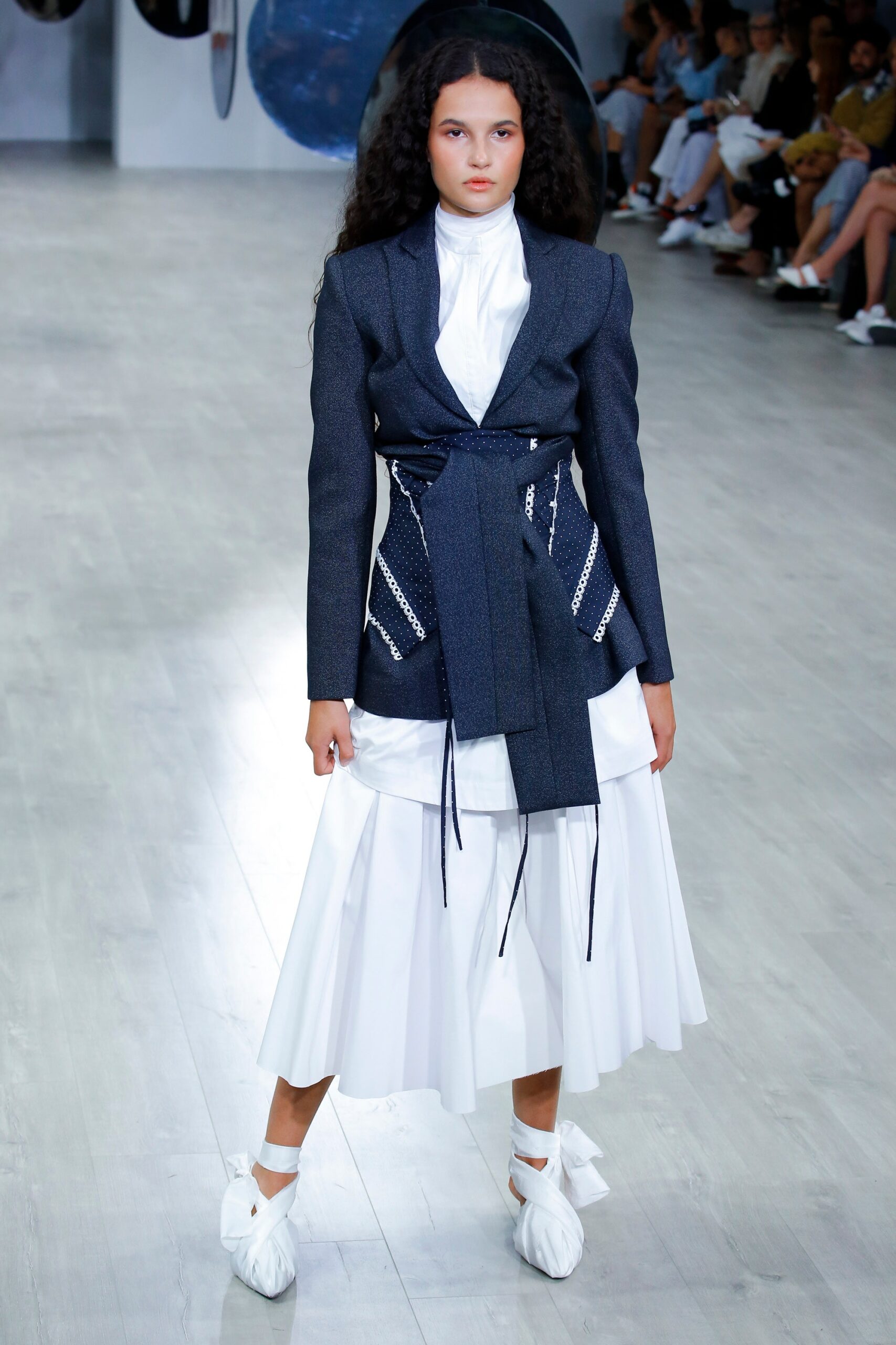 blue tailored blazer with white shirt and pleated skirt