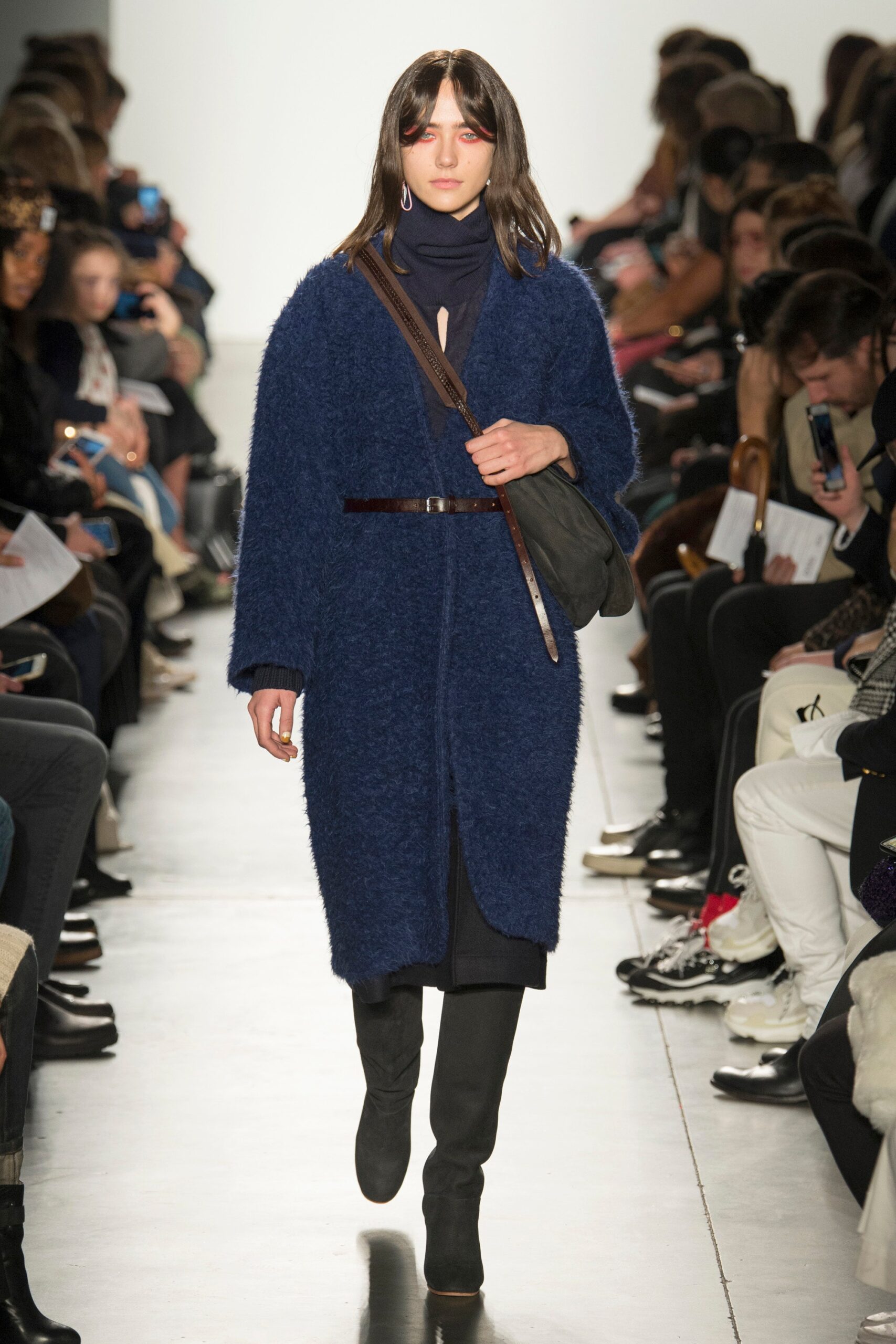 A relaxed blue wool coat with long sleeves and a belted design detail.