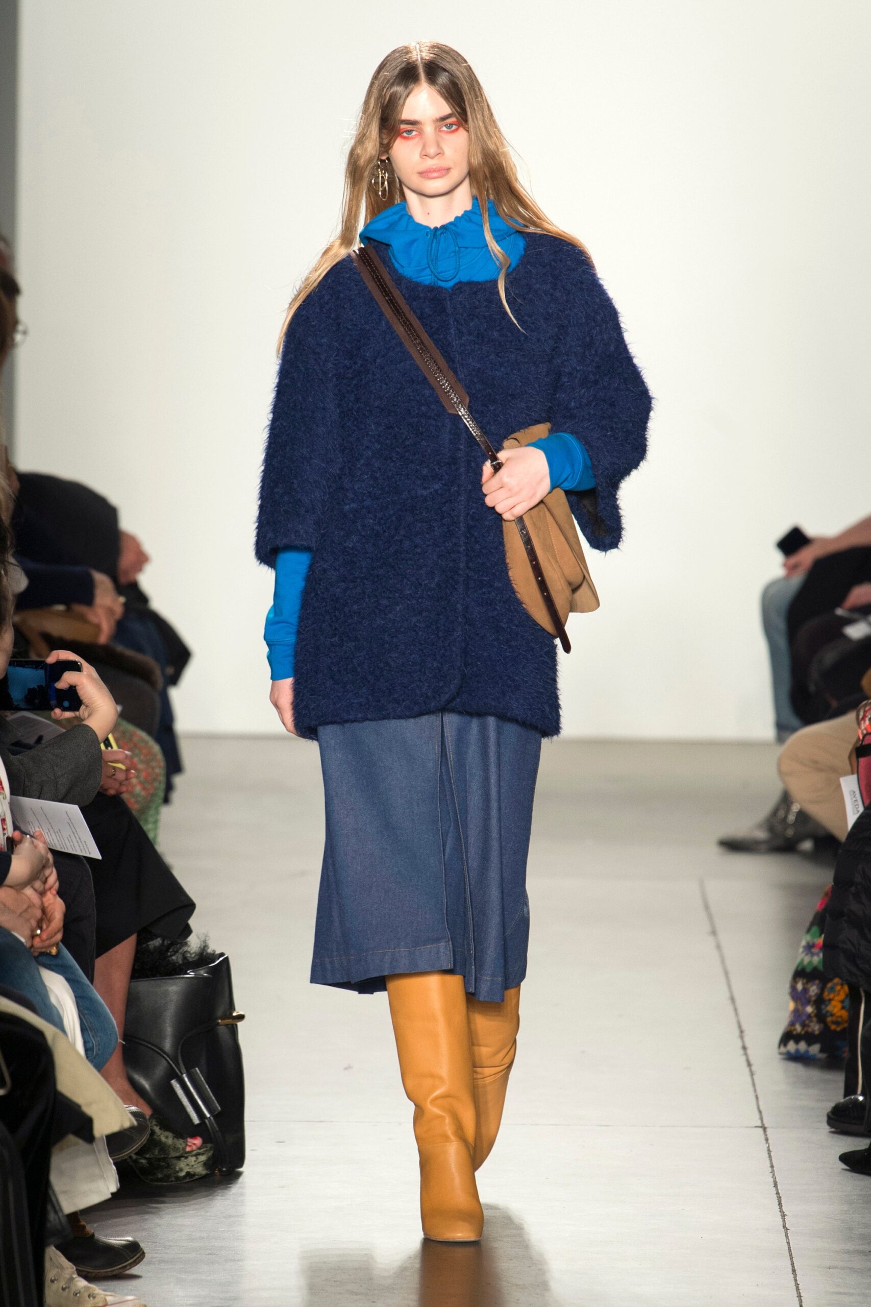 A relaxed blue wool long-sleeve top with a collared neckline paired with a flared denim skirt.