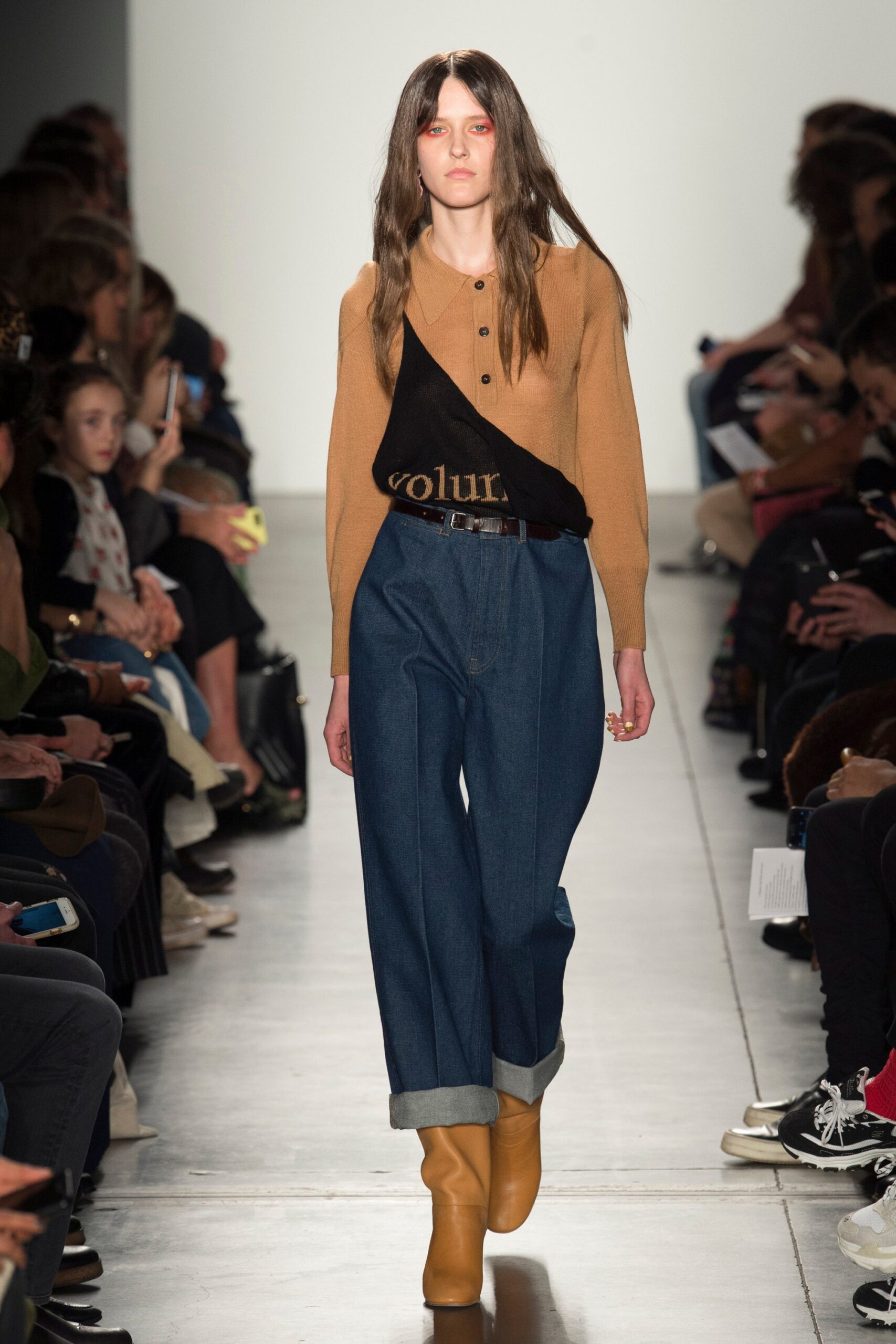 A relaxed brown cotton long-sleeve top paired with wide-leg blue denim pants.