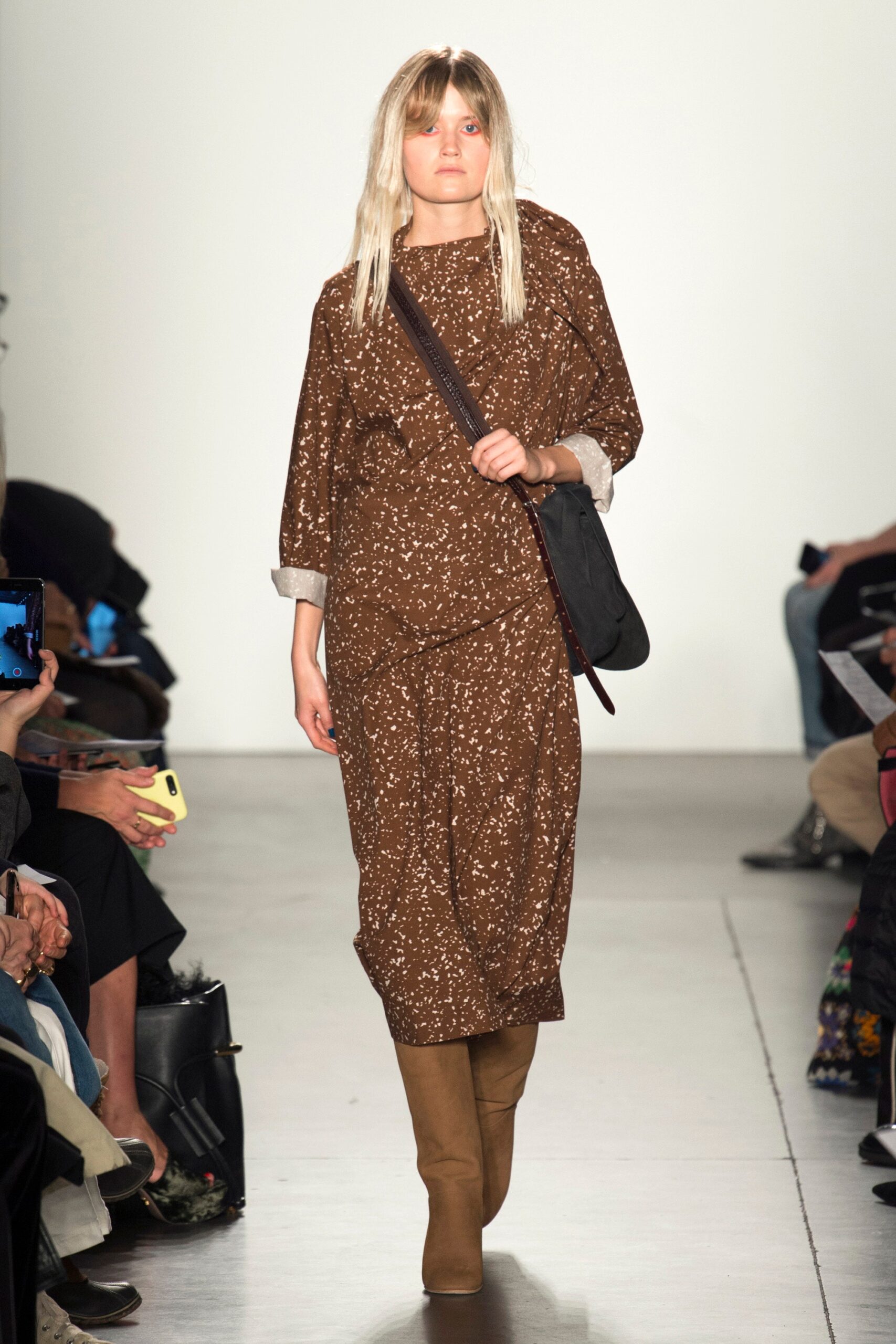 A relaxed brown dress with long sleeves and a collared neckline featuring a printed design.