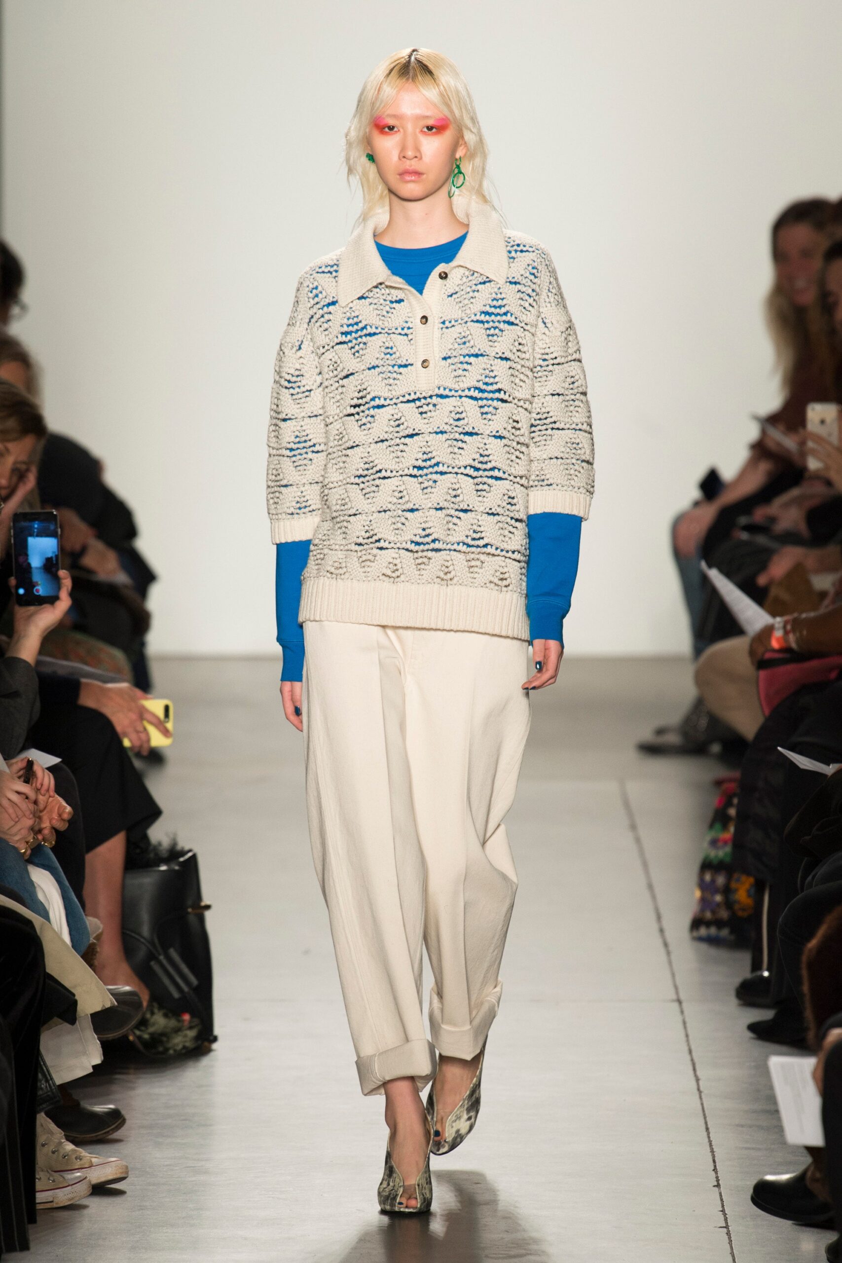 A relaxed white striped short-sleeve sweater paired with comfortable pants.