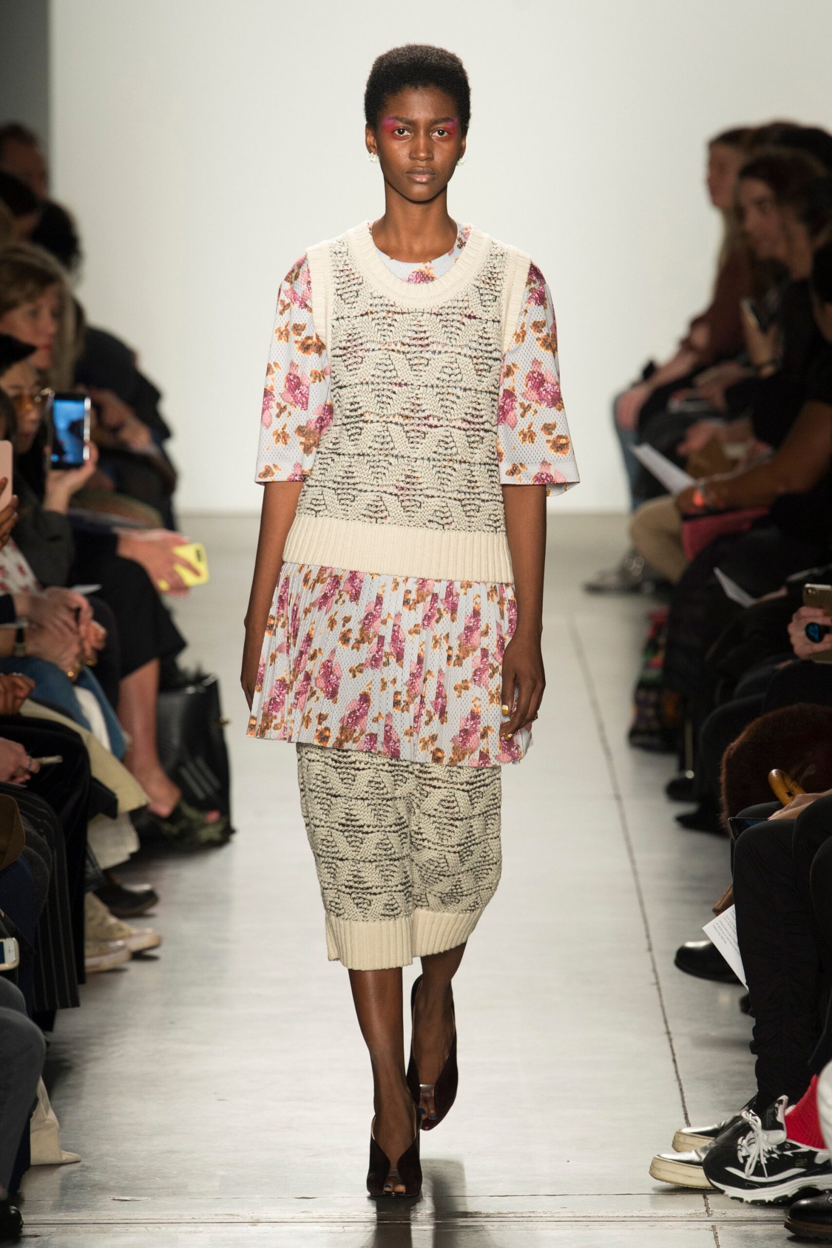 A relaxed beige dress with short sleeves, floral patterns, and a layered design.