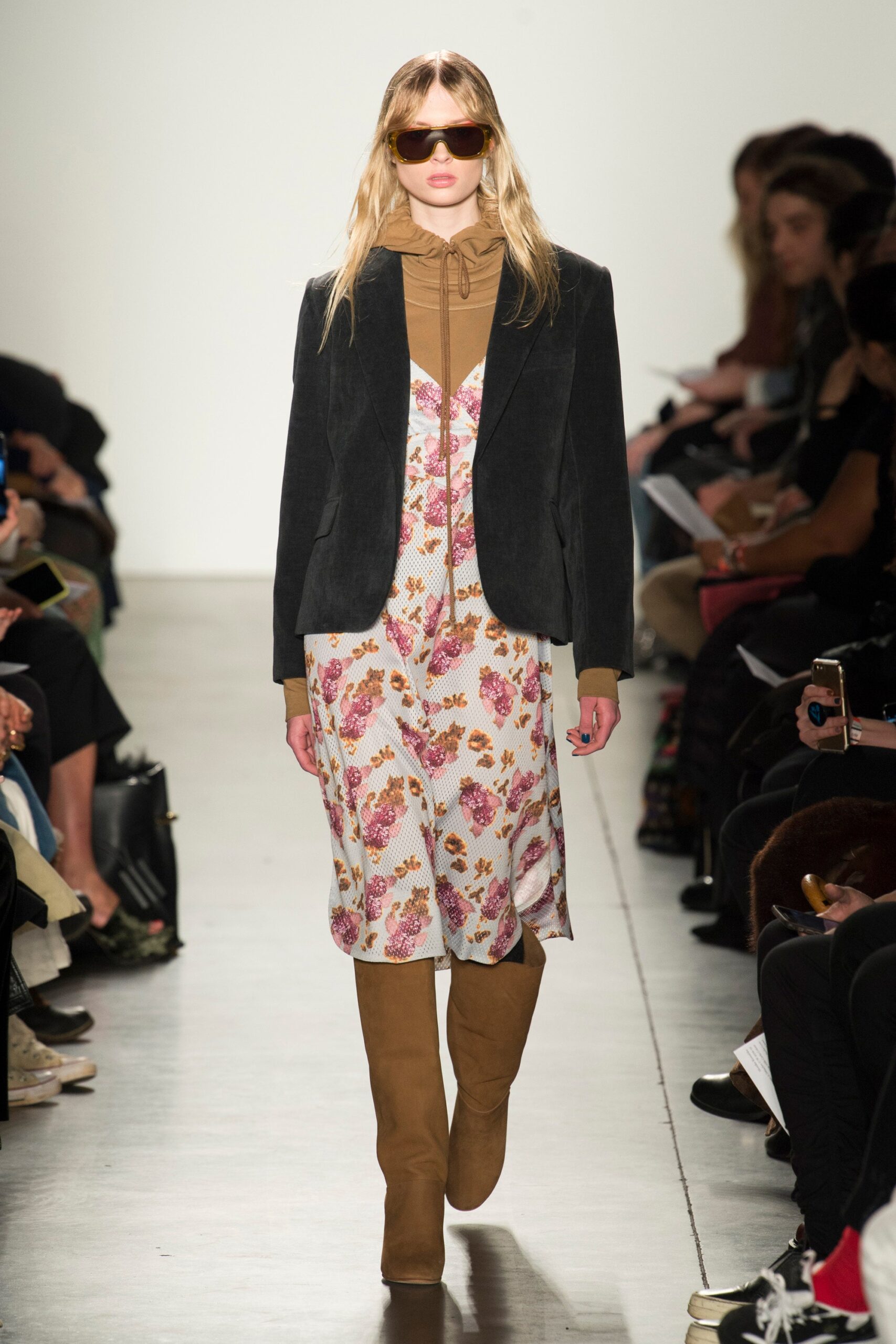 A fitted floral dress layered with a beige jacket, featuring a V-neckline and long sleeves.