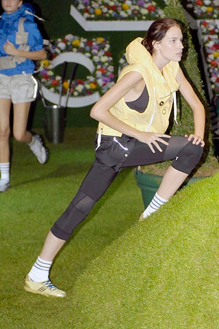 yellow hooded vest with black pants