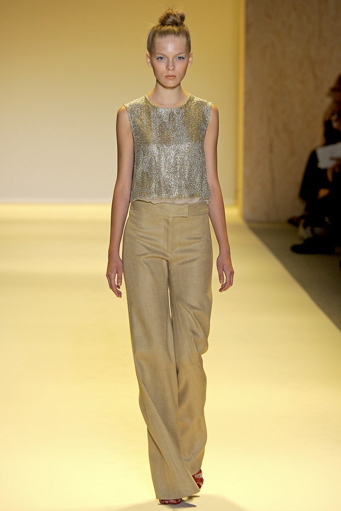 gold embellished sleeveless top and beige tailored pants