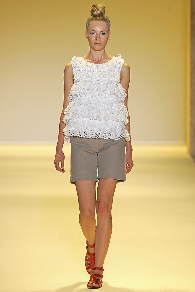 white ruffled top with beige shorts