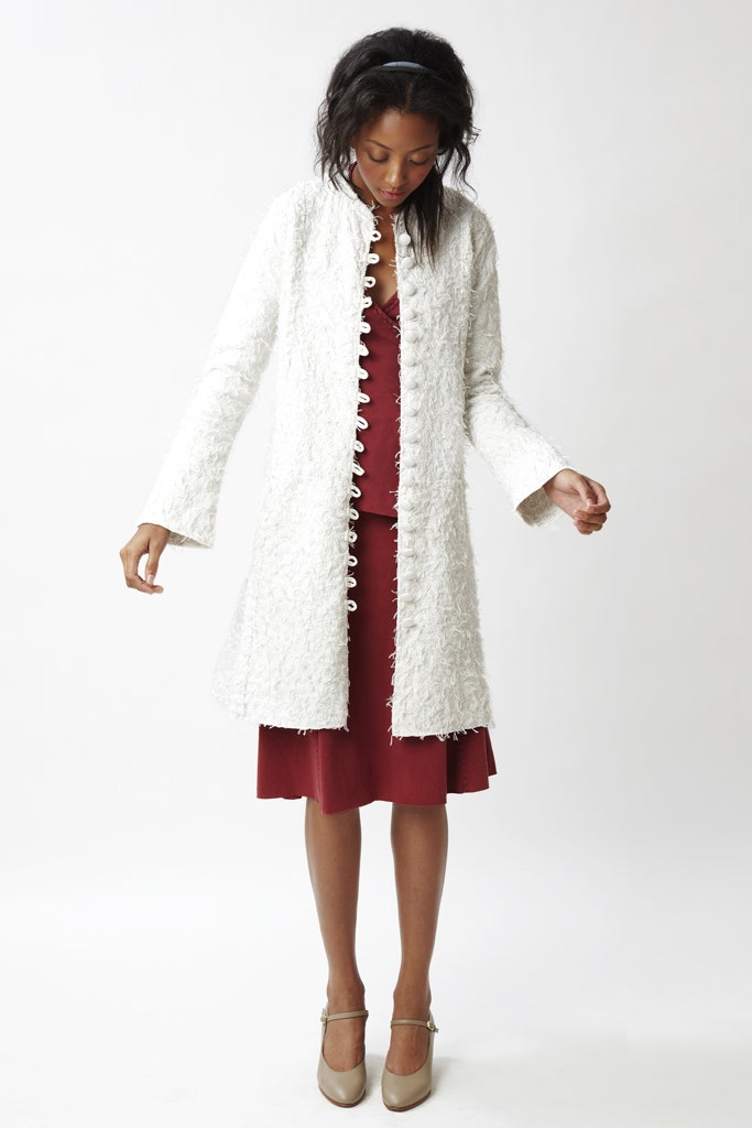 white textured coat and red dress