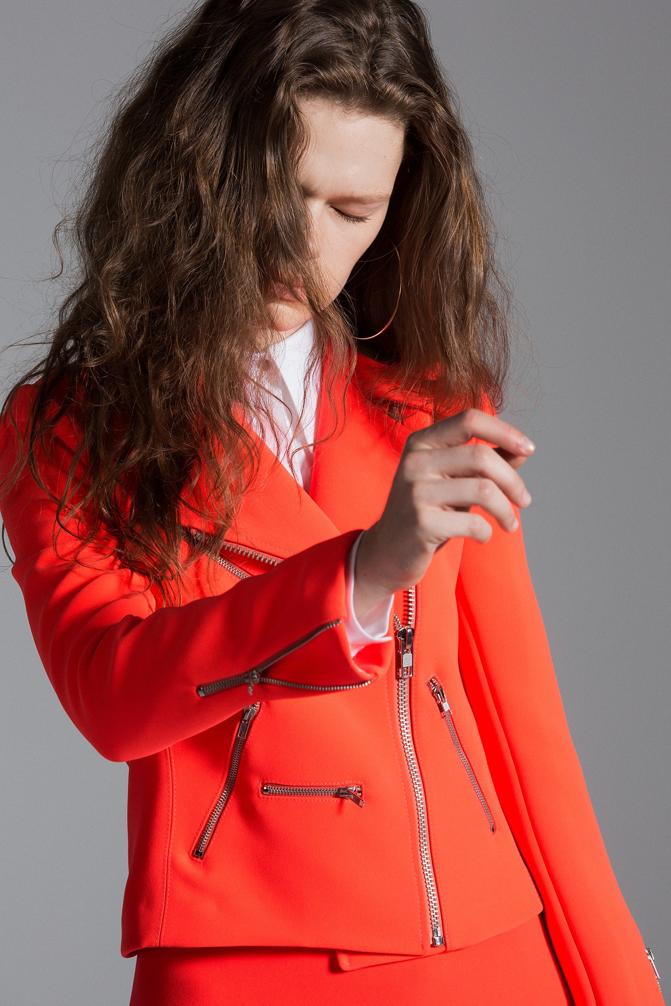 fitted orange jacket and skirt