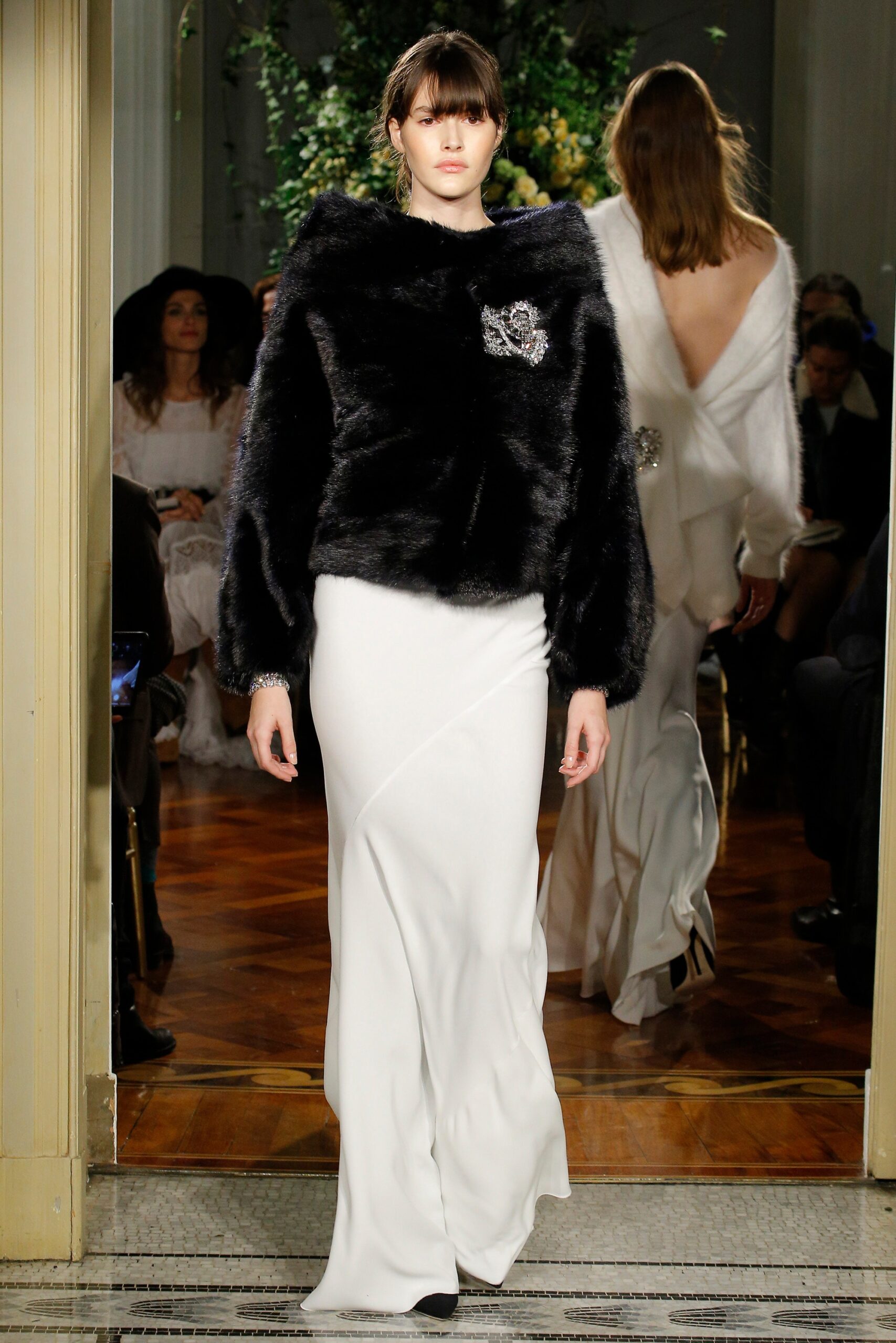 black faux-fur coat and white gown