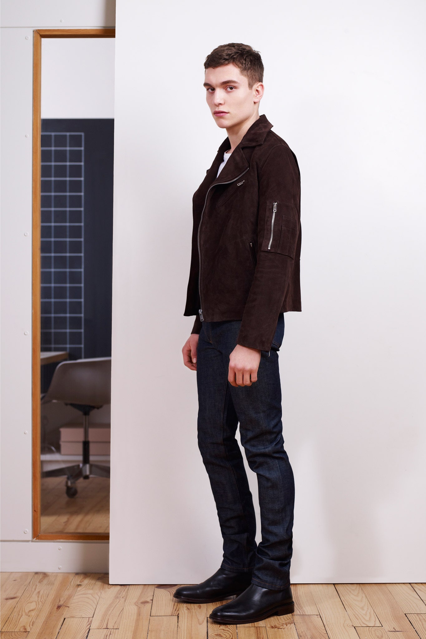 brown suede fitted jacket with blue jeans