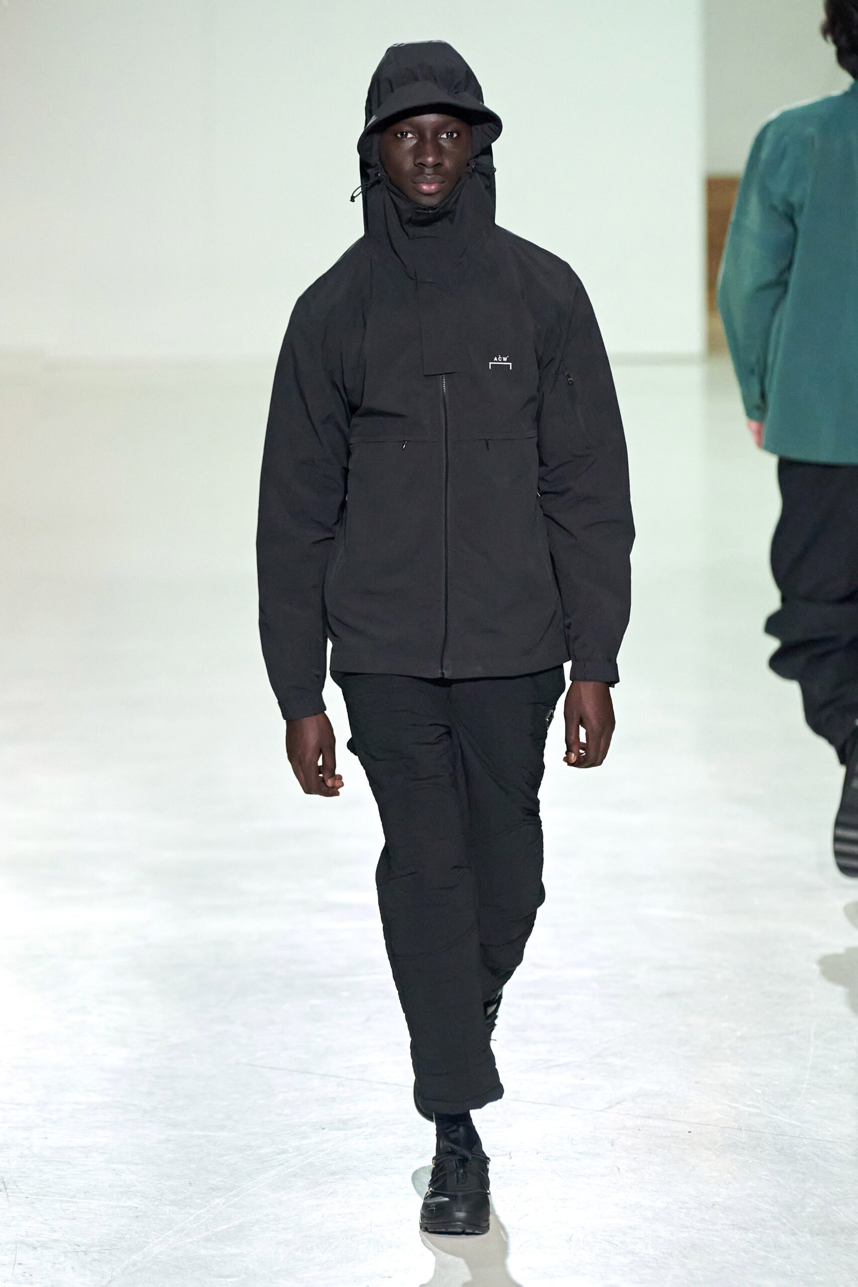 A relaxed black hooded jacket paired with matching pants, featuring a zippered design.